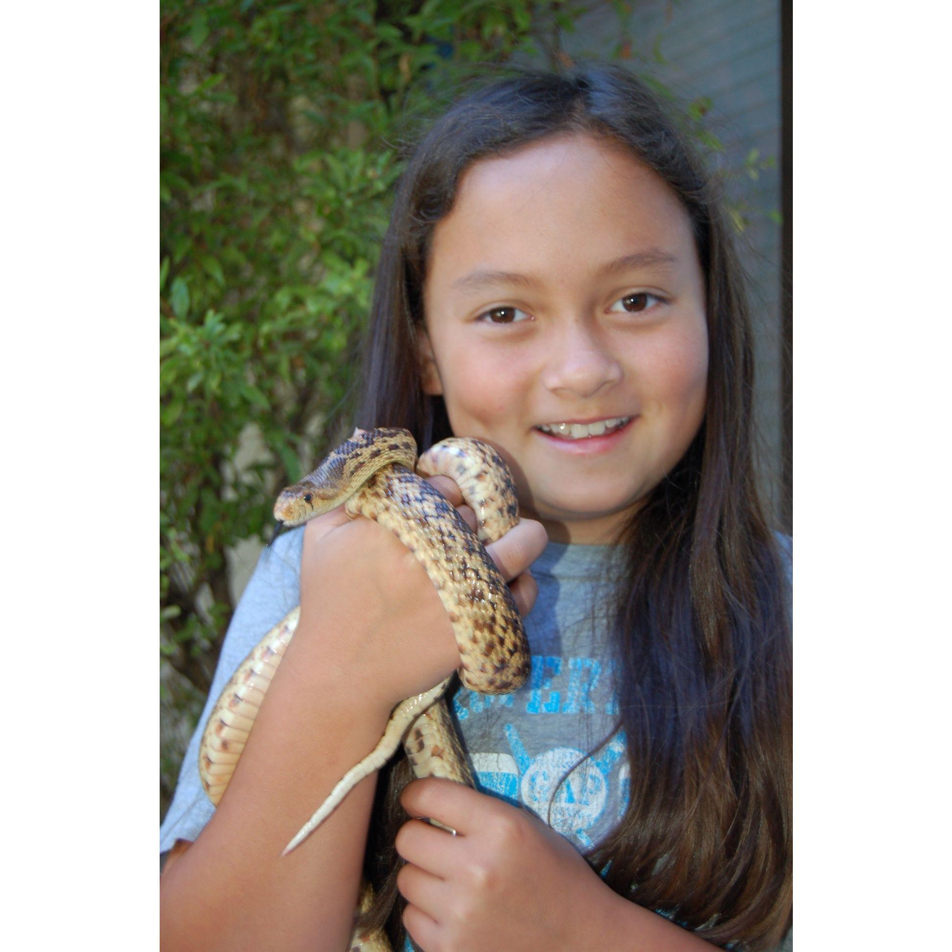 Natalie, somewhere between 8-10 years old, holding her favorite animal!