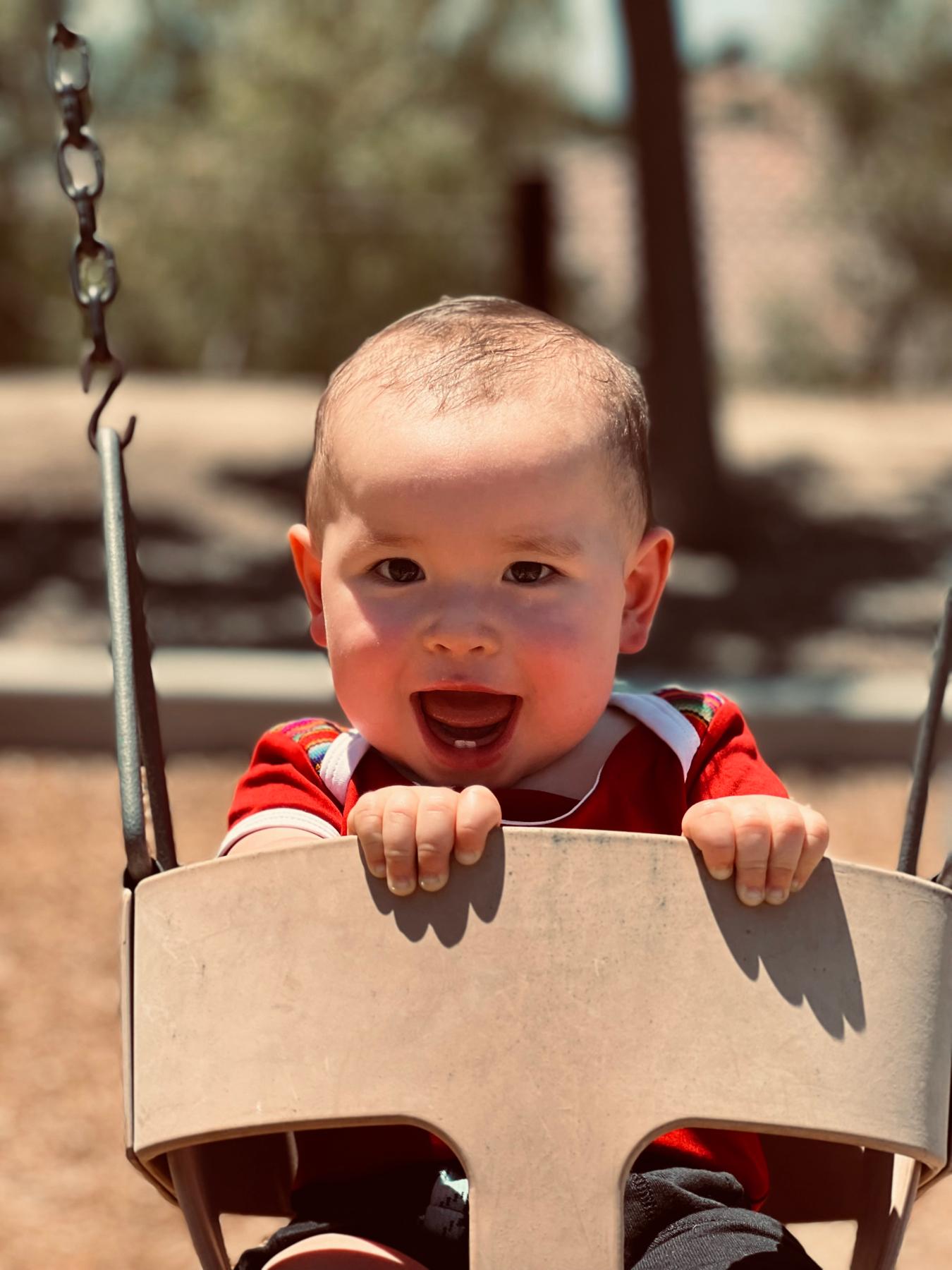 Our son Jude is so happy when he is at the playground on the swings.