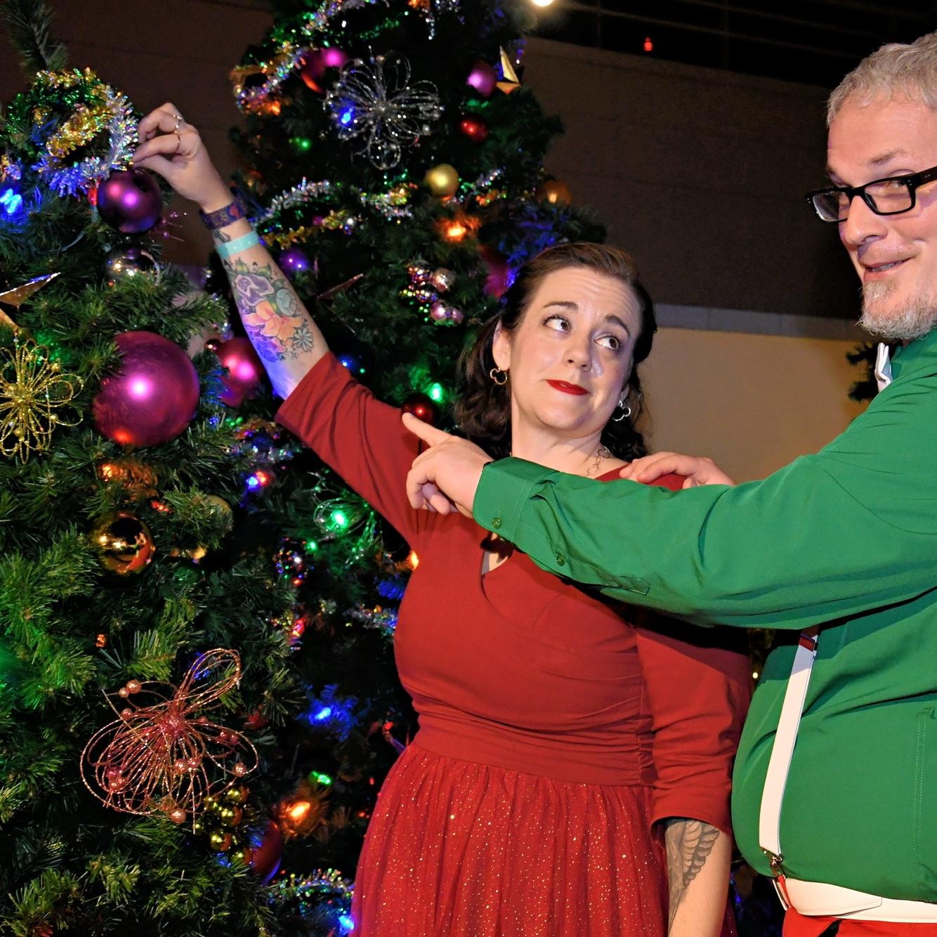 Dexter showing Kari how to place ornaments correctly