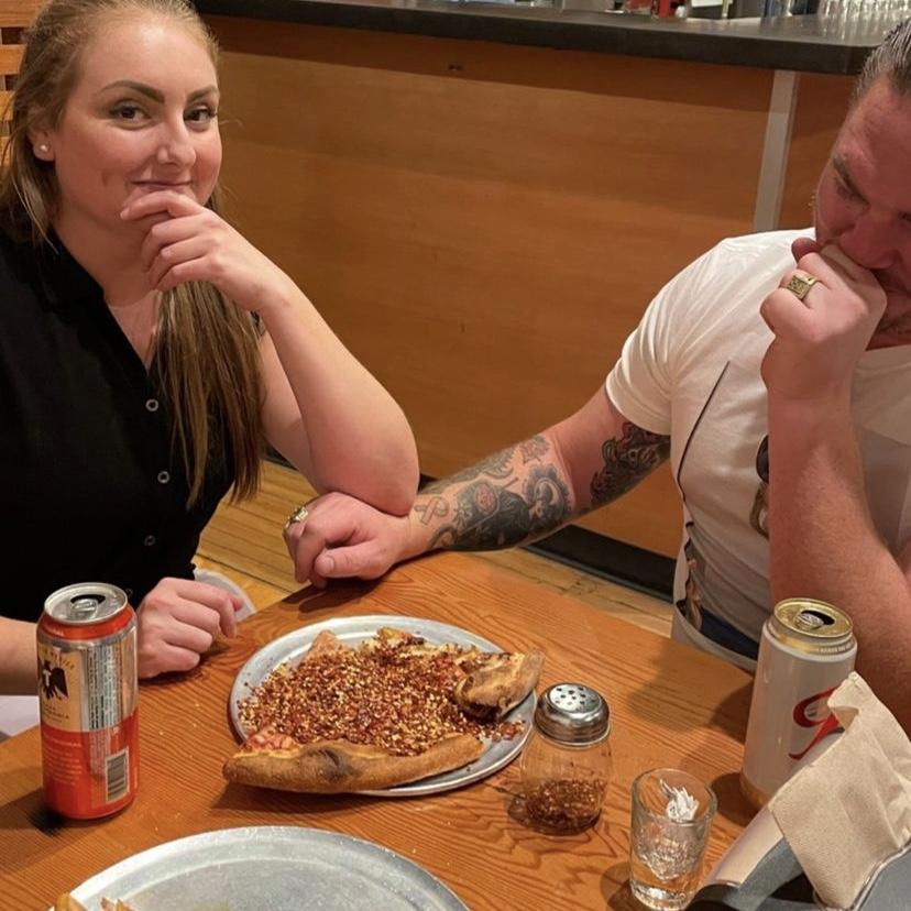 Richard "helping" Heather with some red pepper flakes.