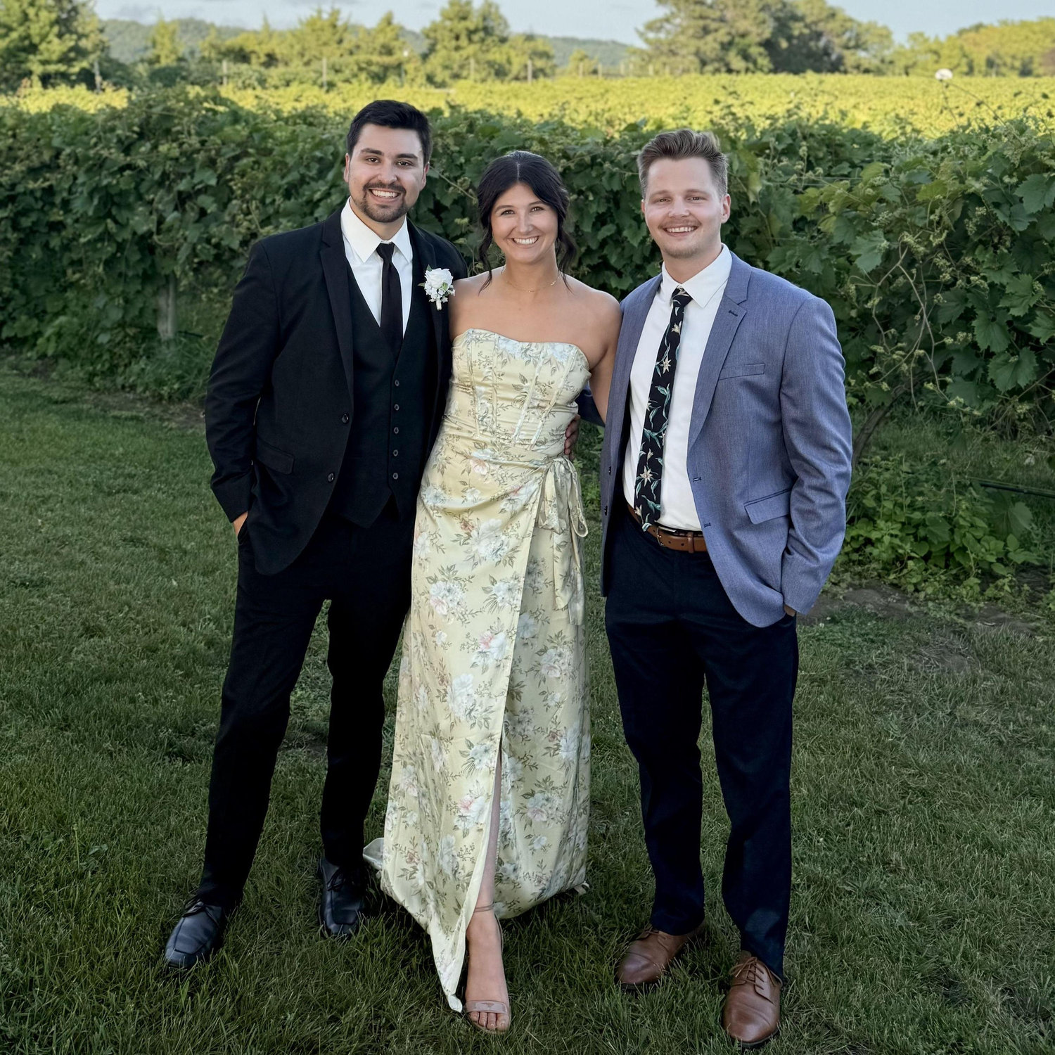 Brady and Victoria with their officiant, Andrew