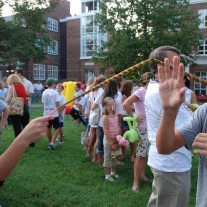 MBA carnival circa 2007. Grace teases Philip with a telescoping popper stick.