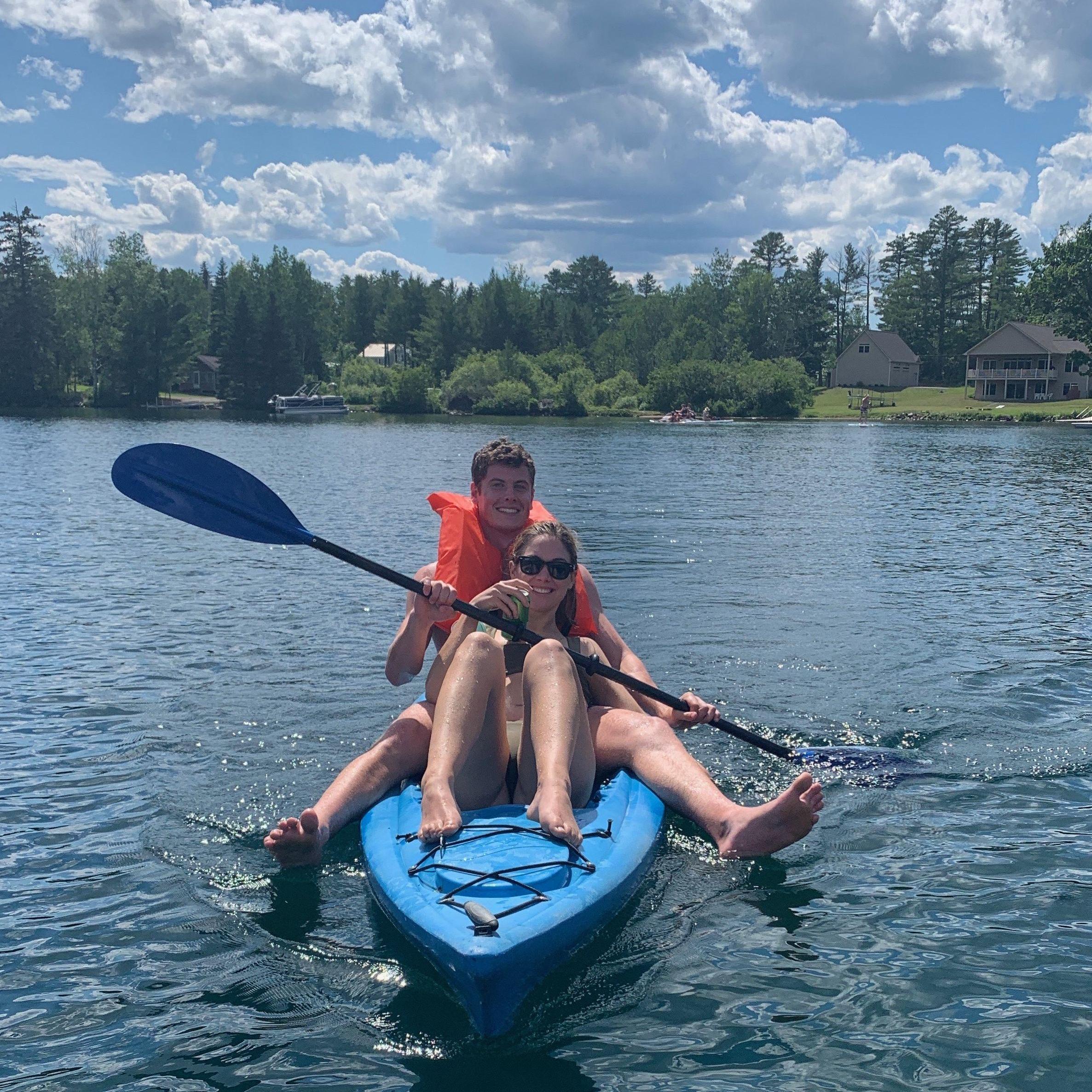 4th of July paddle in our cove of Pleasant Pond. Safety first for Dan, beer first for Ali!