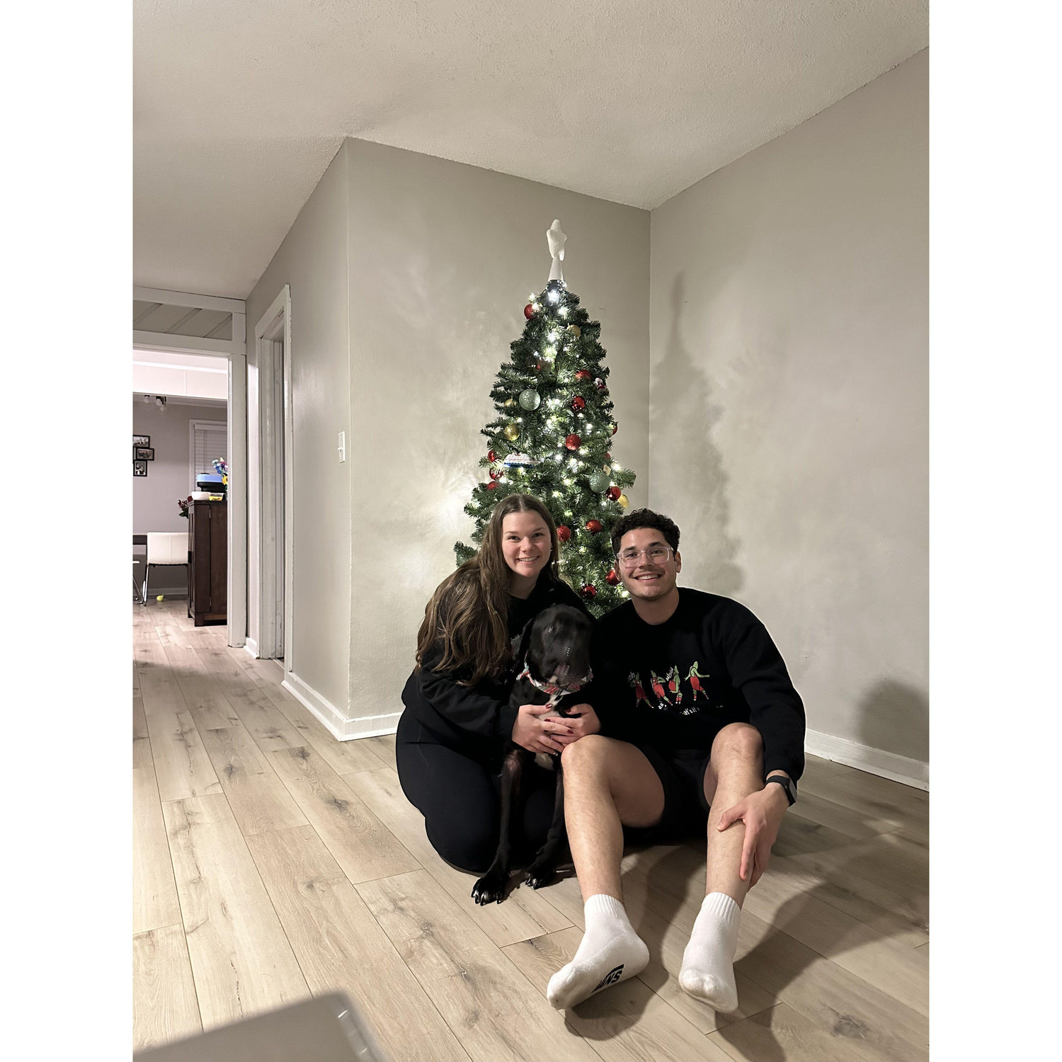 Our little family by the tree in our new house, featuring Mister Bentley