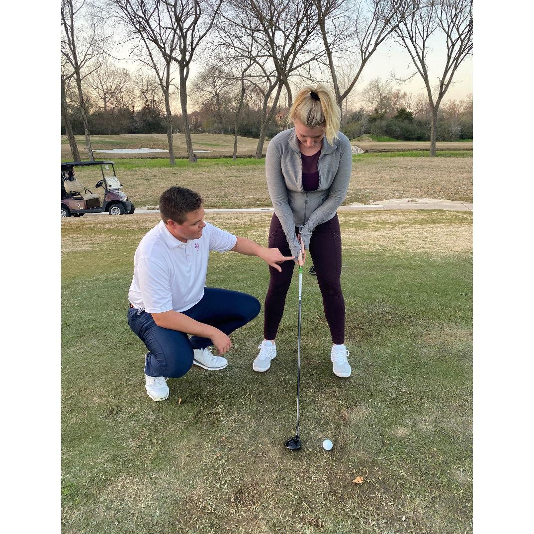 Ryan attempting to teach Kasey how to golf