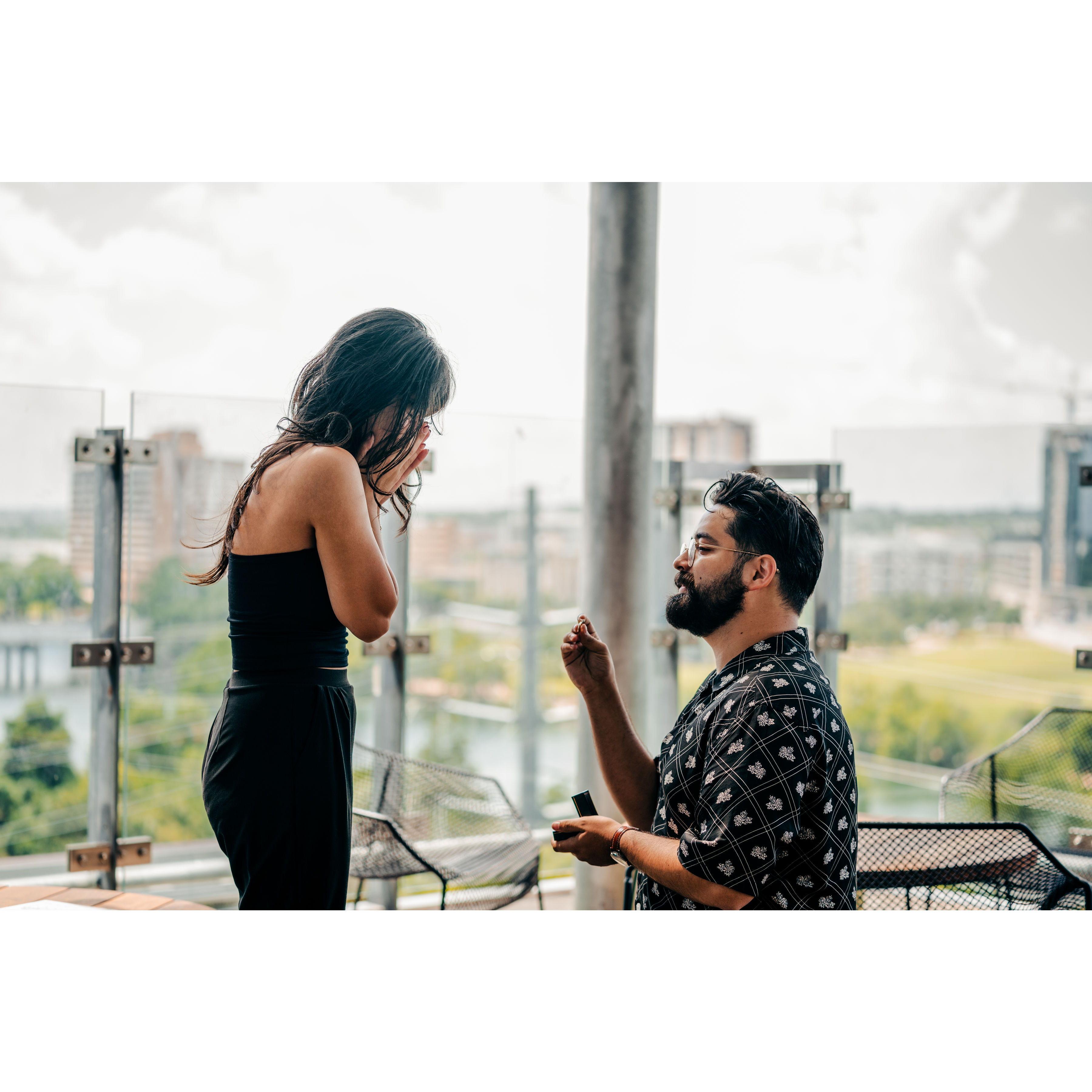 Kieran getting down on one knee to propose.