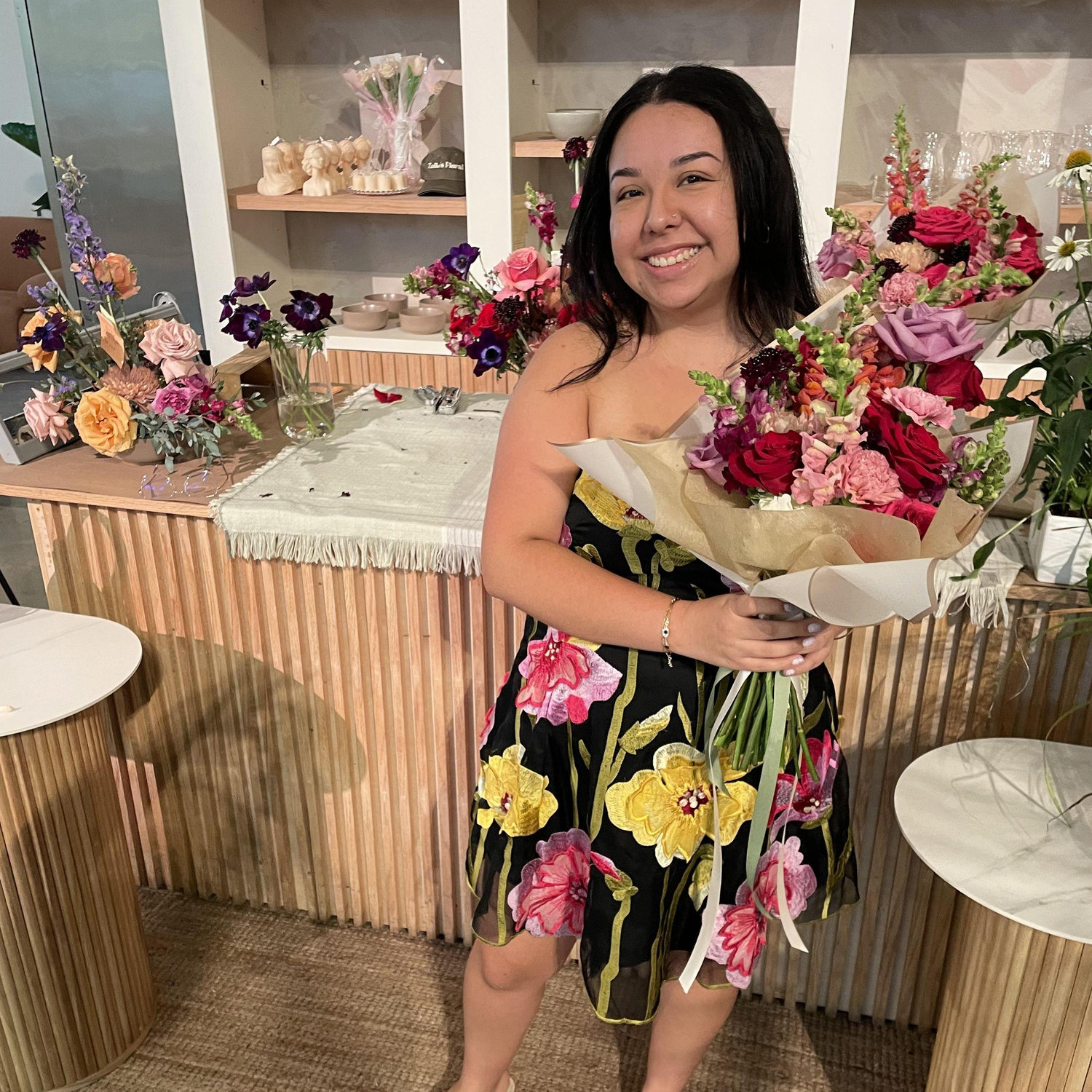 Natali picking up Haley's proposal bouquet, inspired by the event poster from their first date.