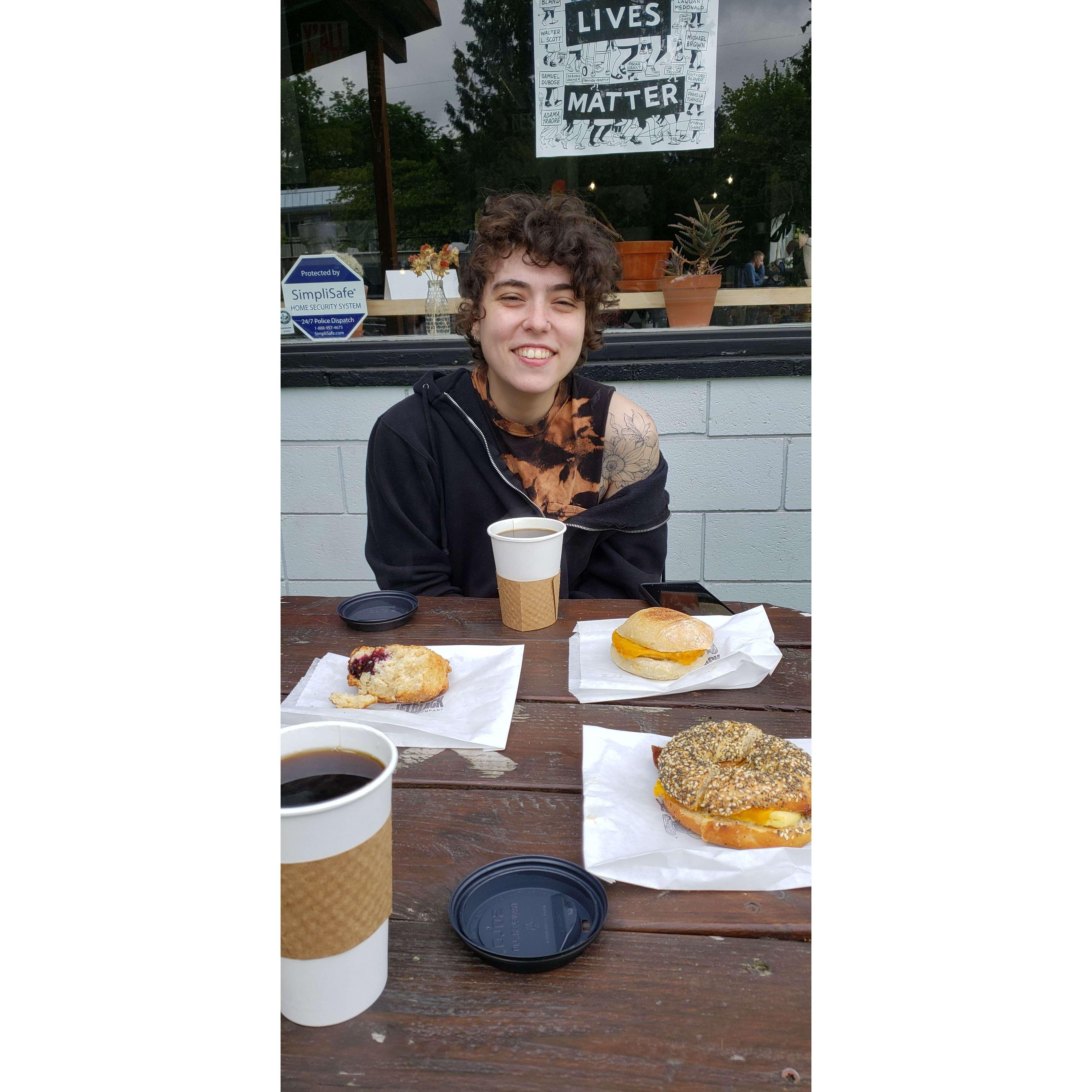 Rex enjoying a nice coffee and breakfast sandwich in Portland