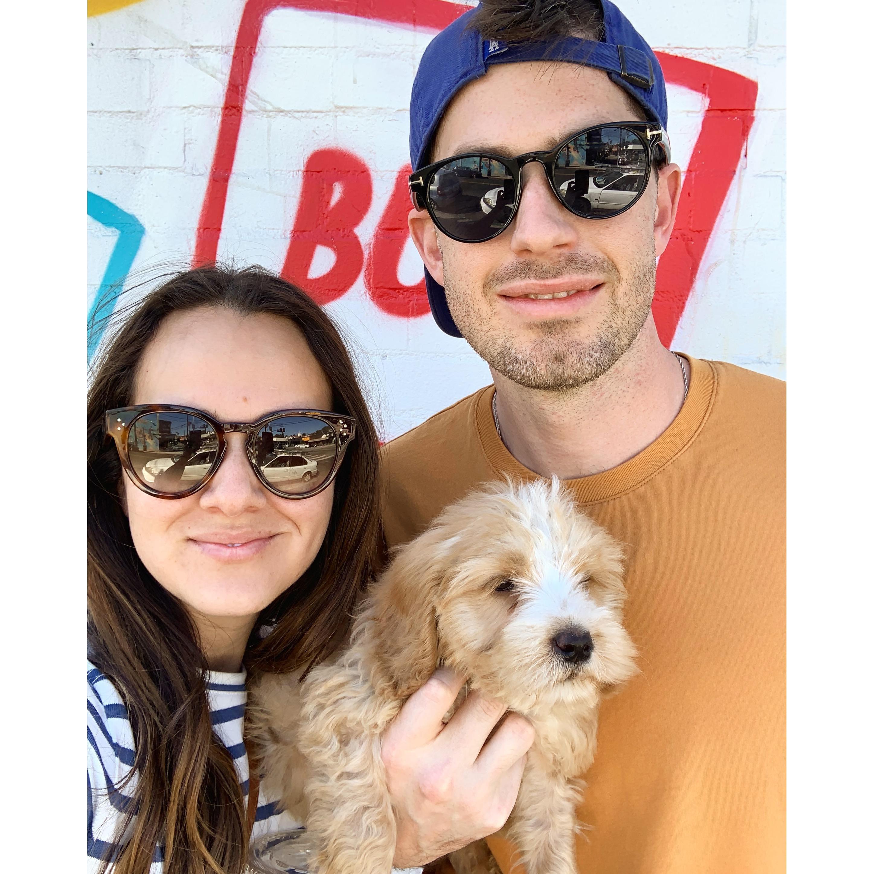 This is our baby and the newest member of our family, Cooper! We got him on March 2, we're obsessed with him, he sleeps in our bed, and he can't wait to meet you at the wedding!