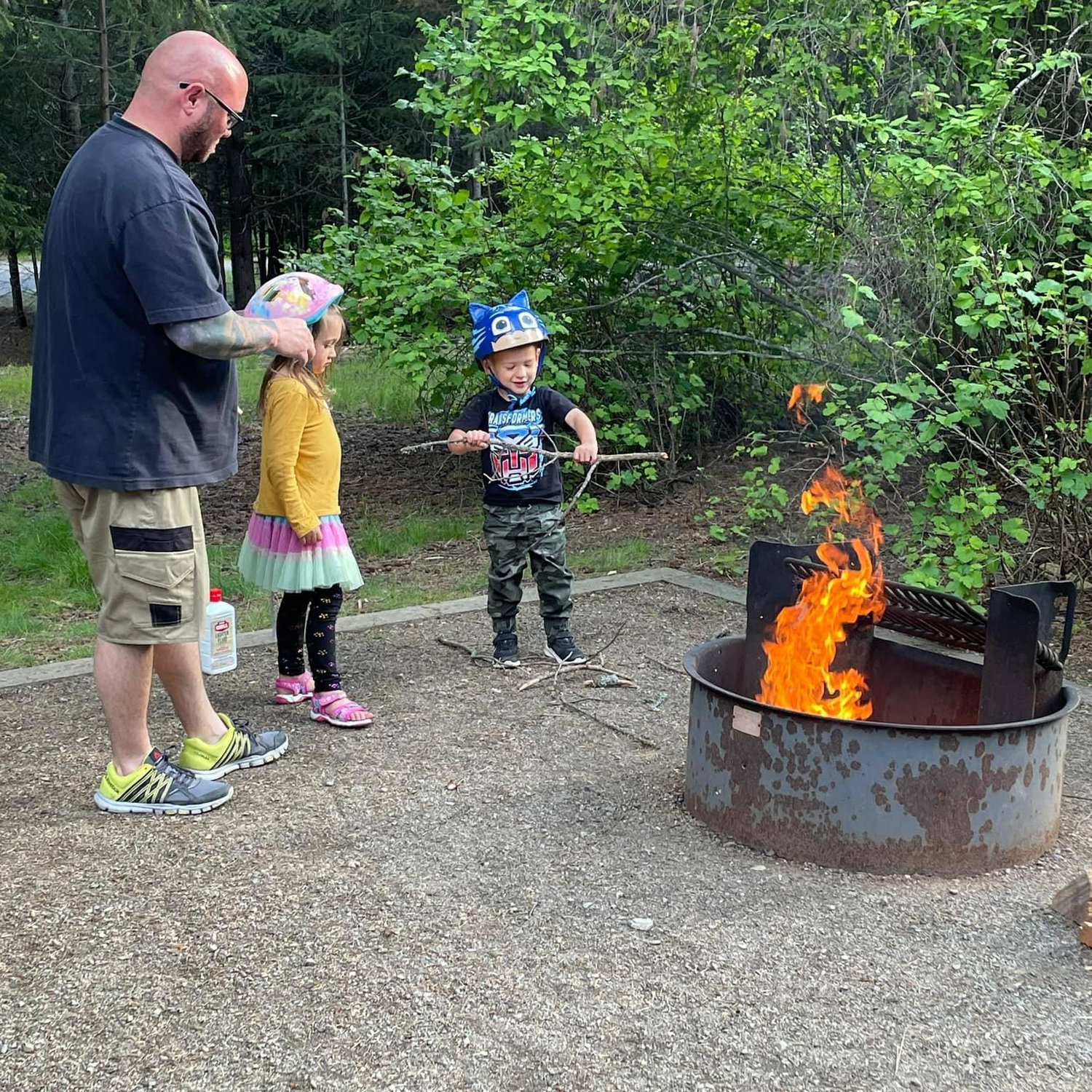 Bailee and Benny helping Uncle Doug with the fire while we were camping