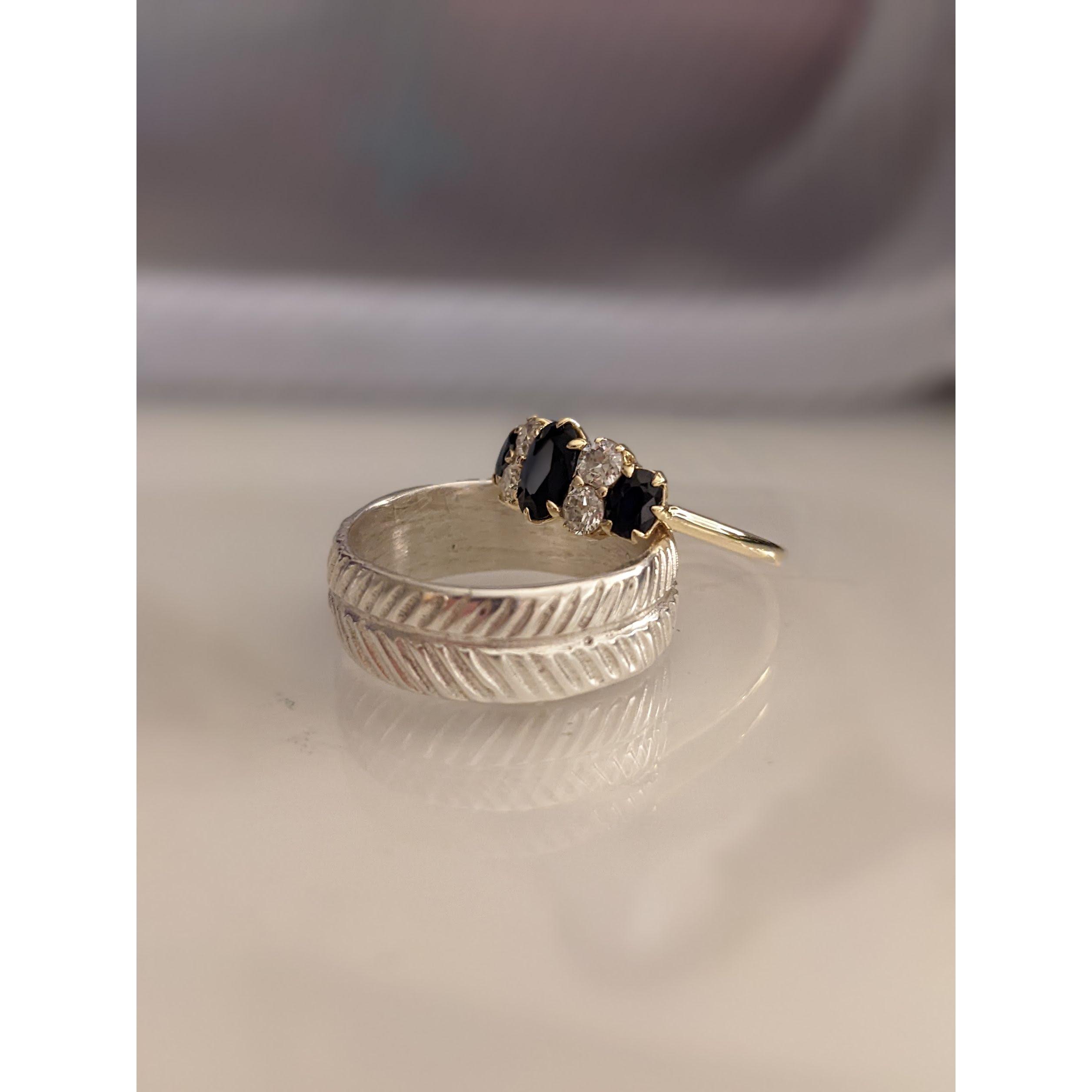 Shelby's ring is a Vibert family heirloom.  It belonged to Chris's great aunt, Marjorie.  Chris's ring was hand carved and casted in silver by Shelby.