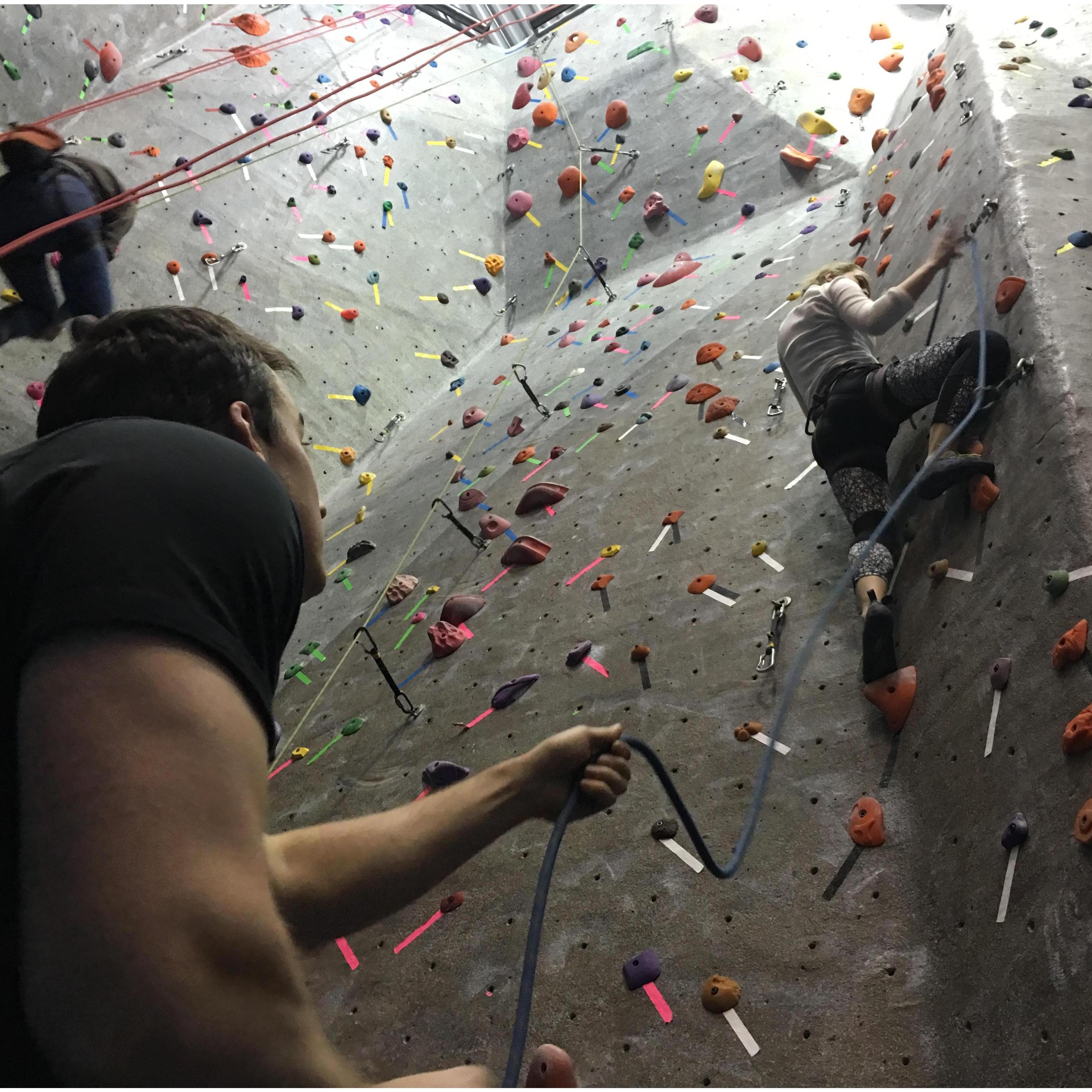 Josh teaching Mariah to lead climb