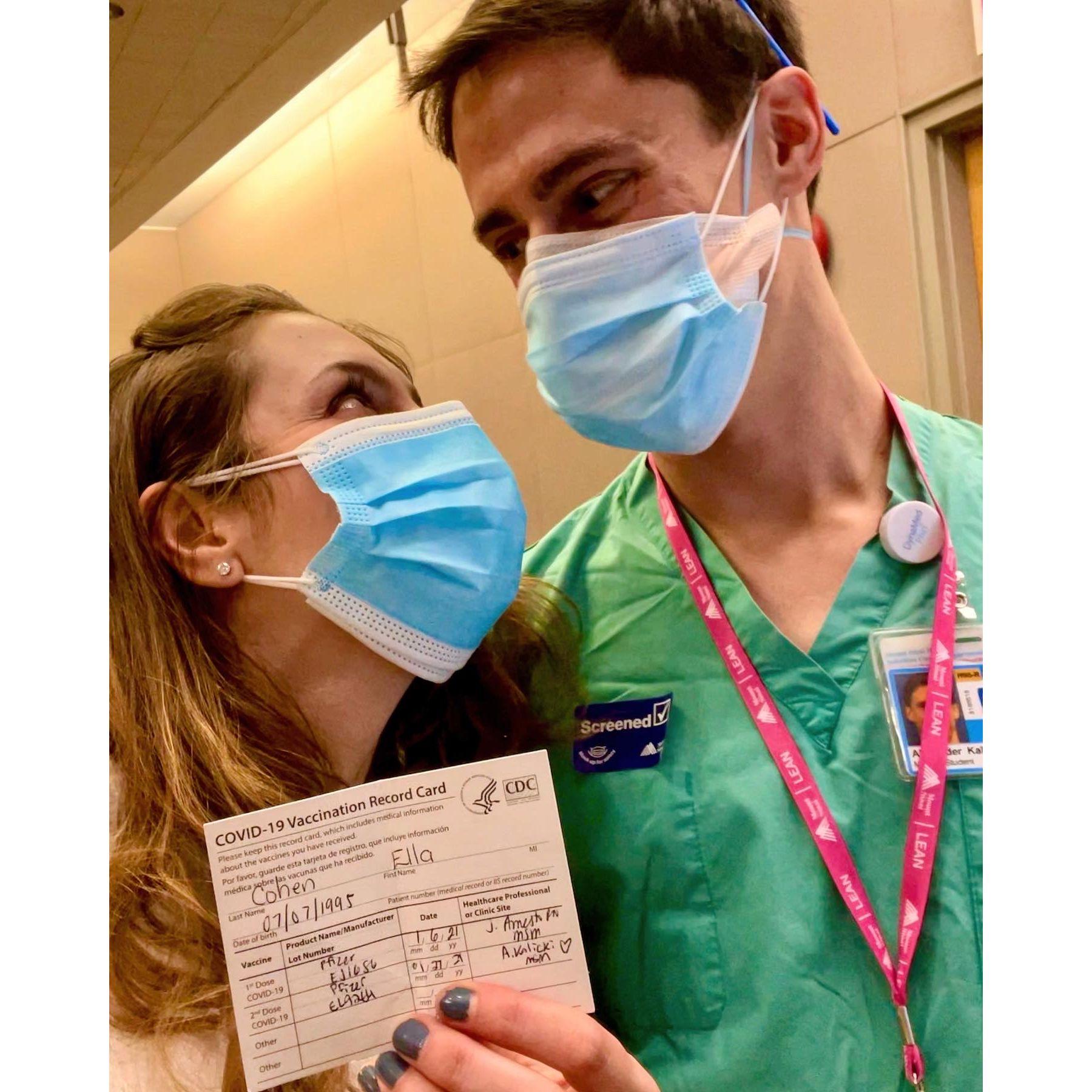 A photo from 1/2021 after Alex gave Ella her COVID vaccine! She was lucky to be able to get the vaccine at this point, and even luckier to have such a cute vaccinator!