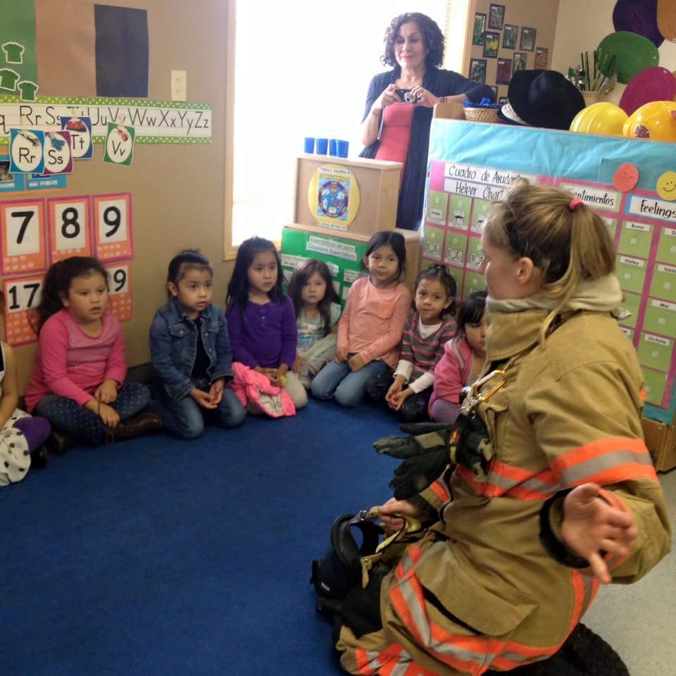 Jenny teaching kindergartners that firefighters may LOOK scary during a fire but they are there to help you out!