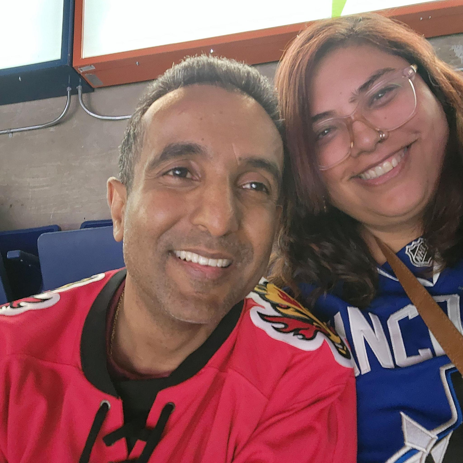 Our First Hockey Game- Zahra wearing a Vancouver Jersey and Raheman wearing a Calgary.. Guess who won this game?