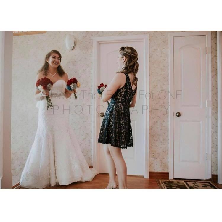 The bride and bridesmaid laughing before descending the stairs to start the ceremony 
Photo credit to: A Heart That Beats For One Photography