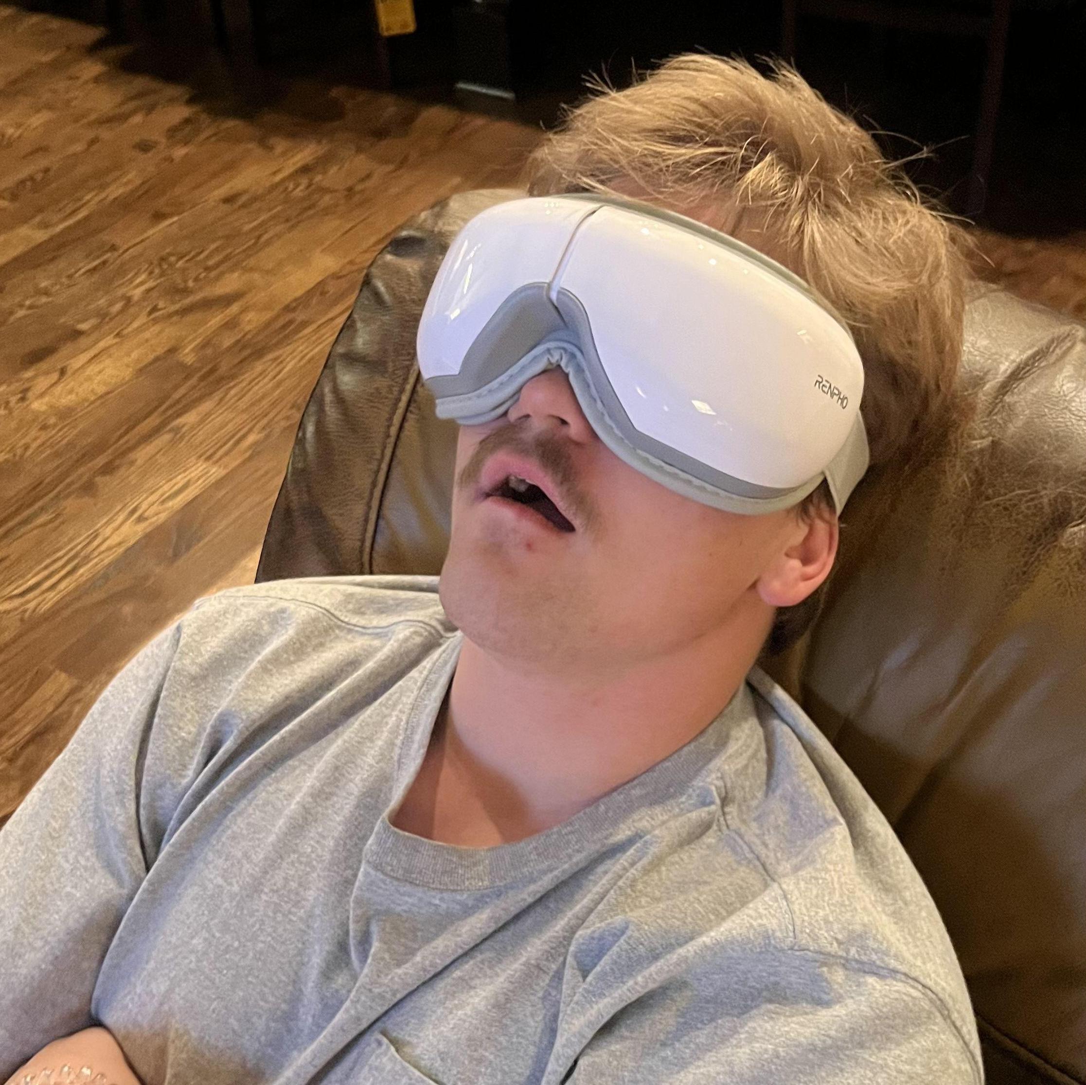 Eli on Christmas morning trying my mom's eye massager she got.