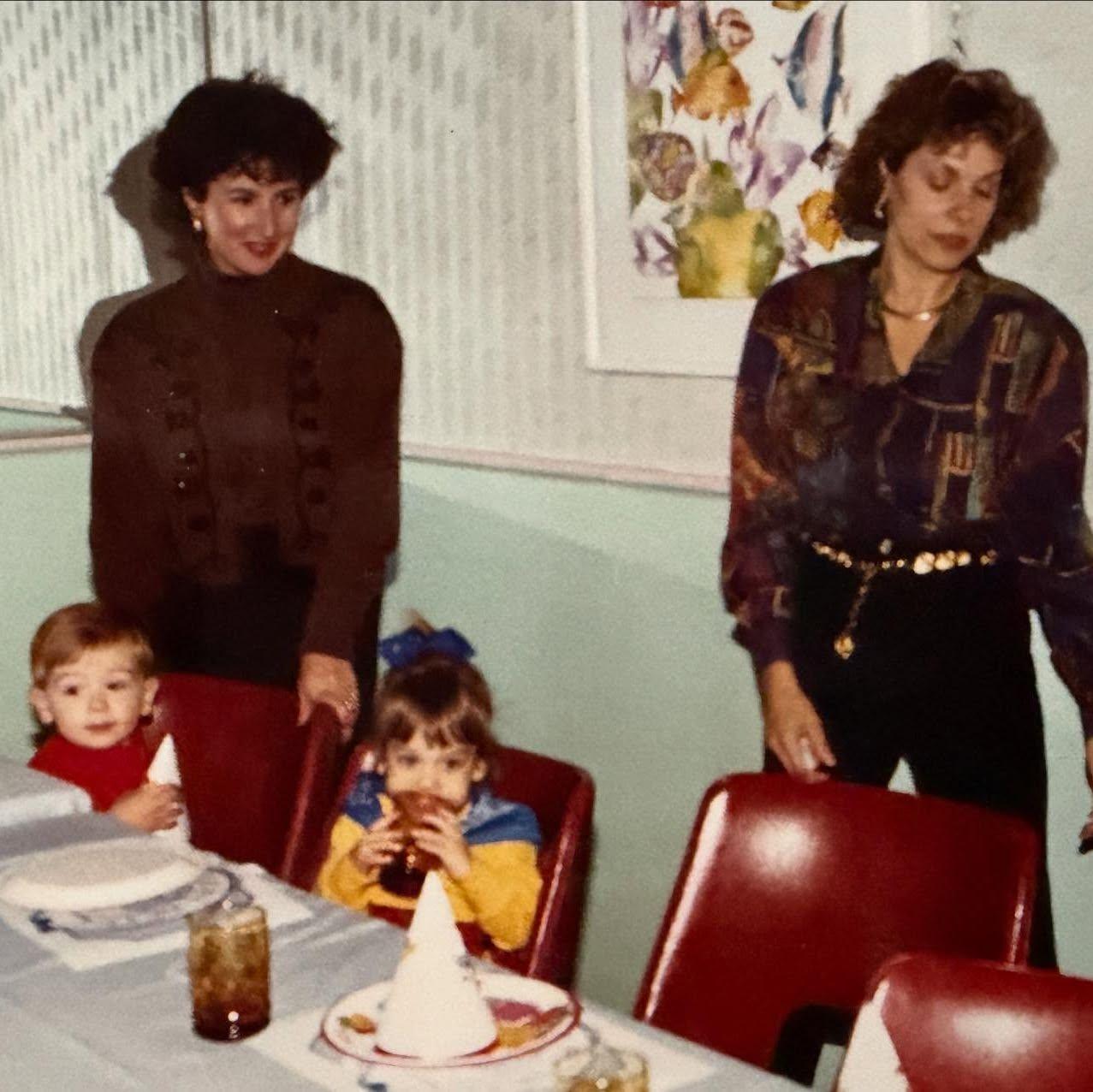 Us as babies at a birthday party with our cool, fashionable moms!