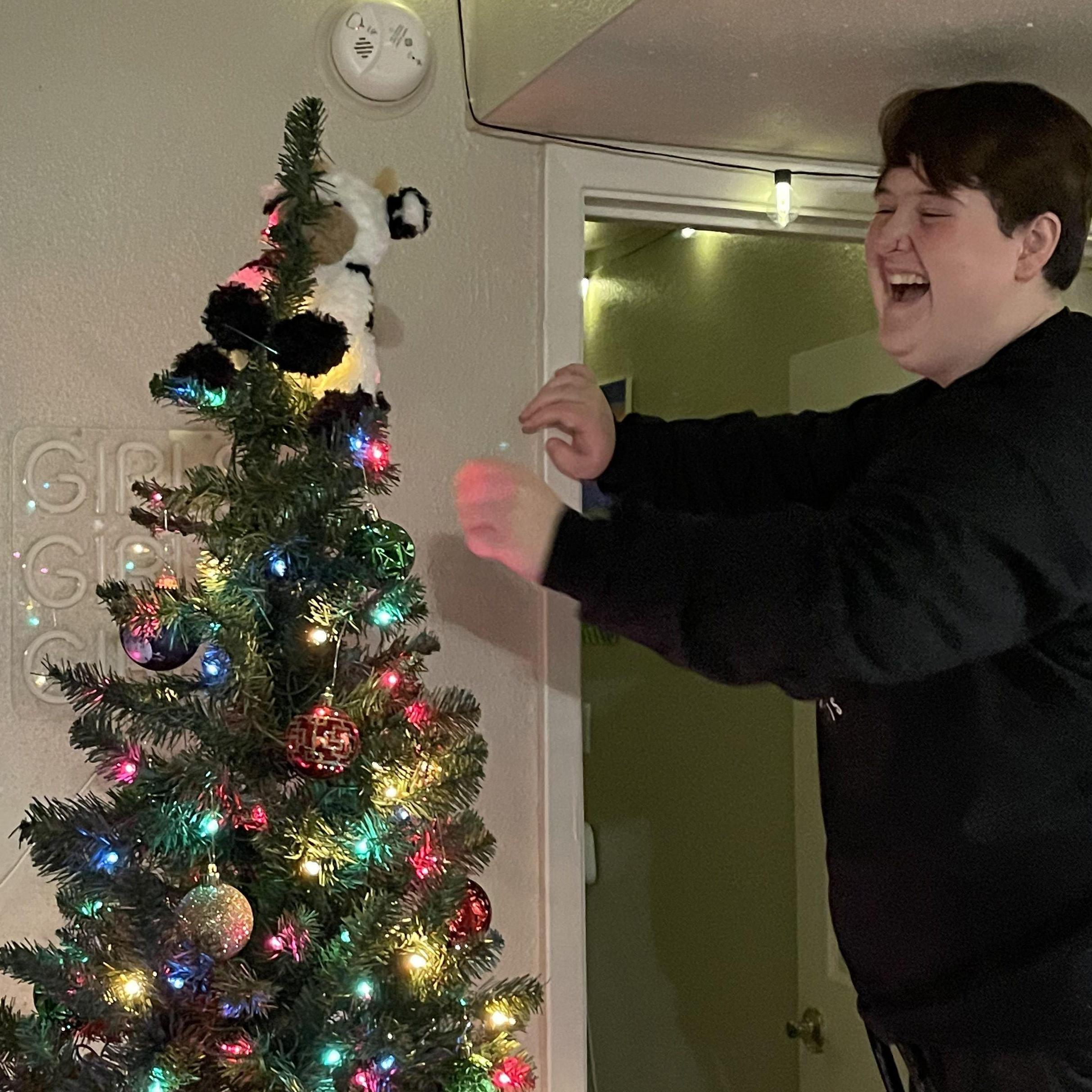 We didn't have a tree-topper for our first Christmas together, so we put one of our stuffed animals - Colin - up there instead. Plus look how cute she is next to the tree. -Carissa