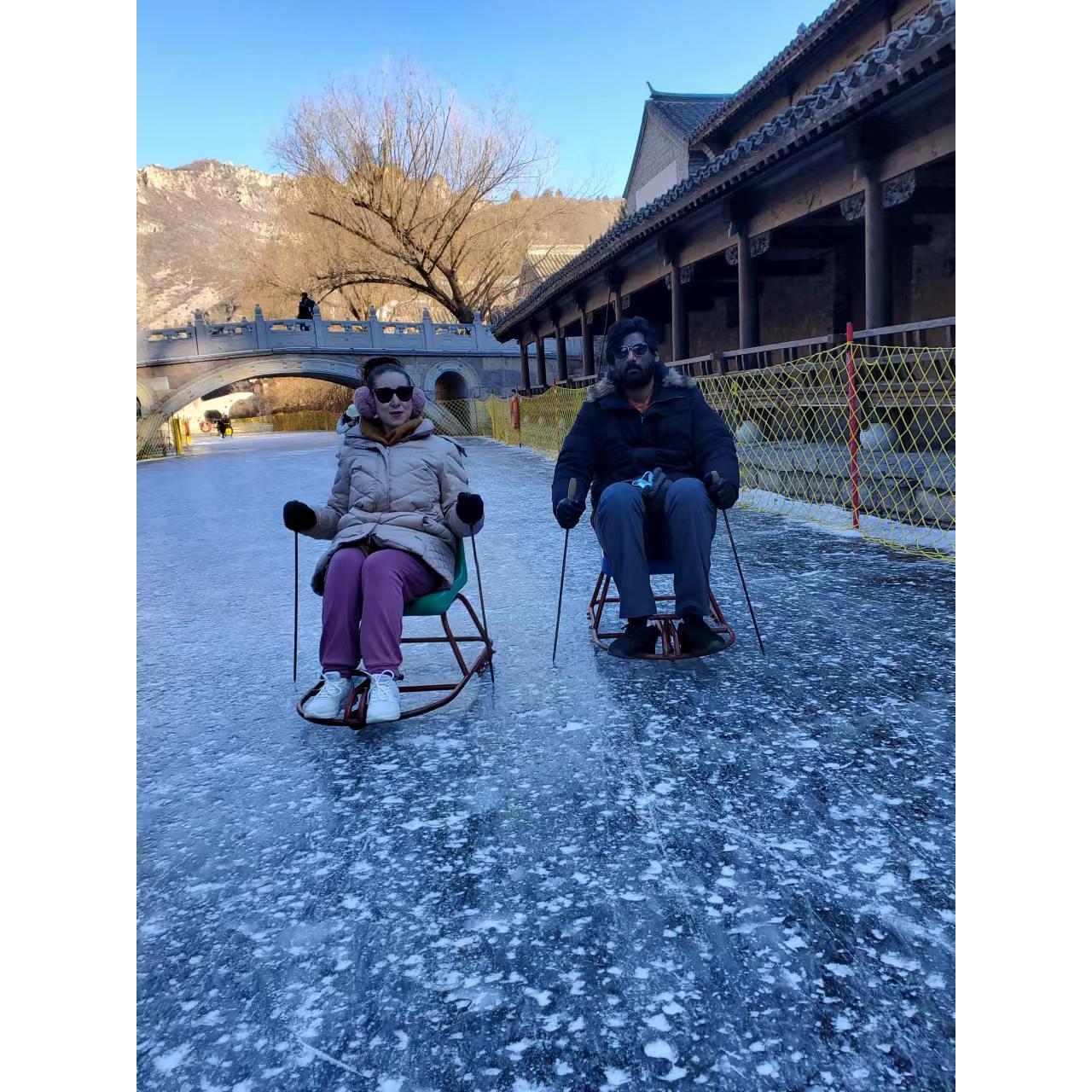 Raj and I having fun doing the ice chair activity at Gubei Water Town