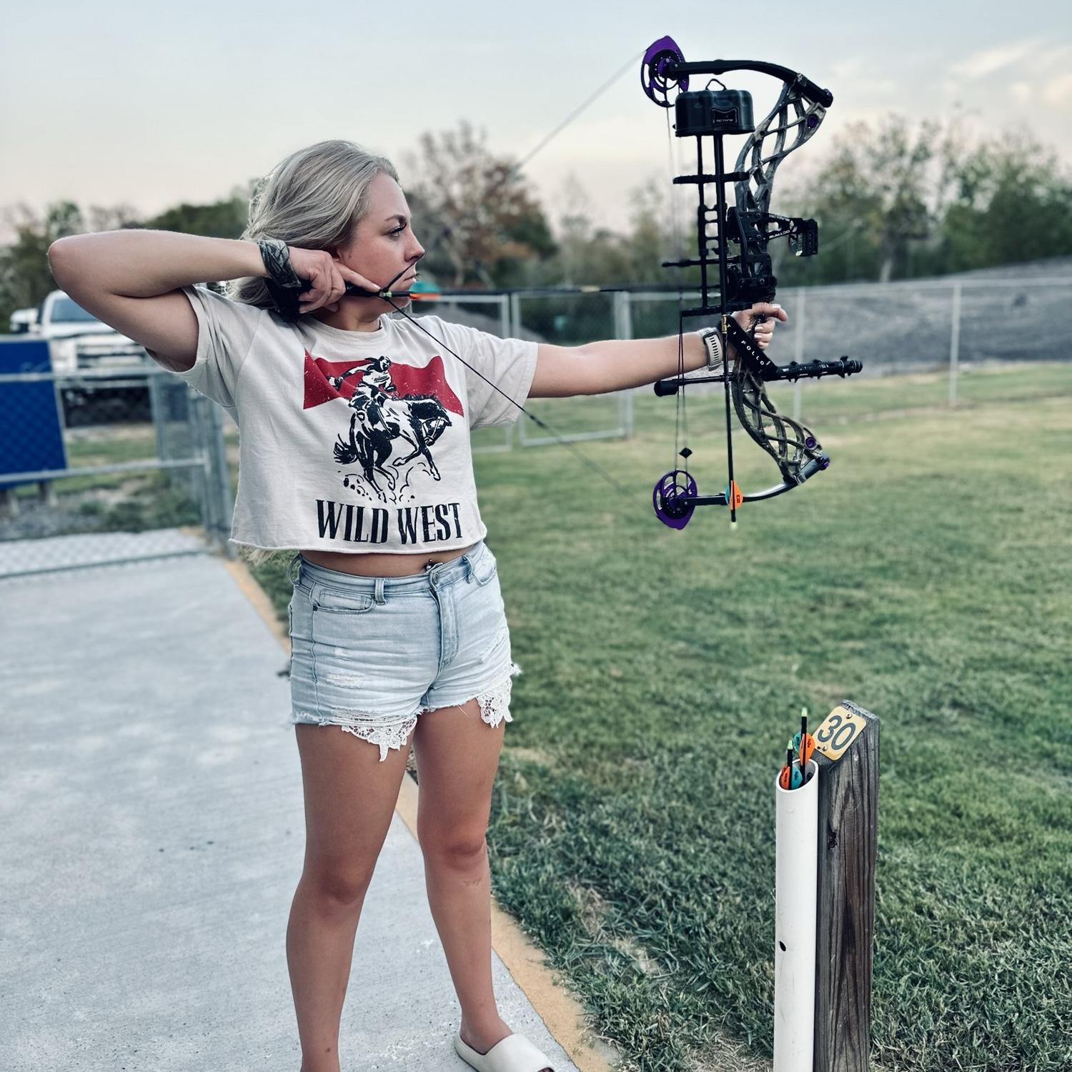Bailey shooting at the archery range in Texas