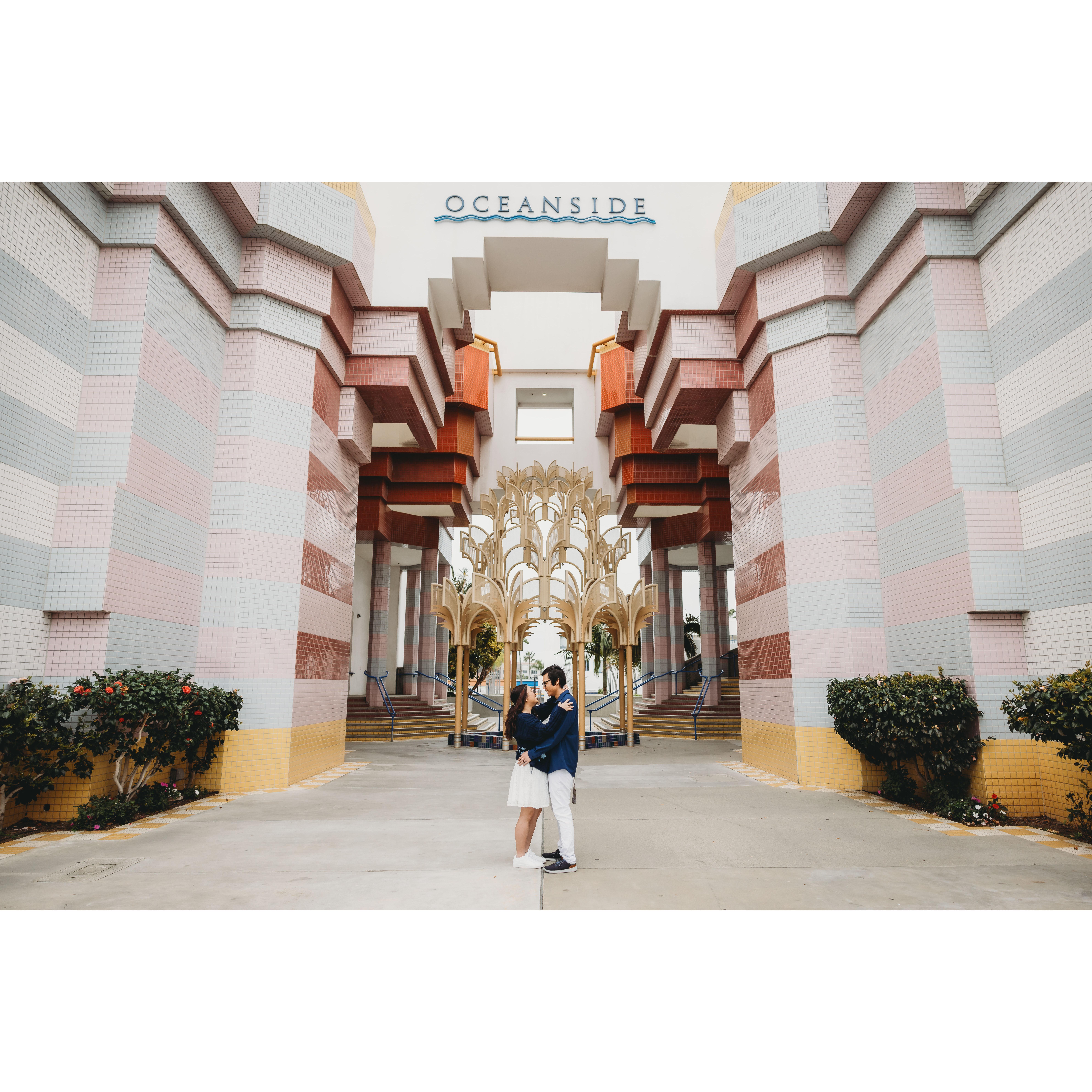 Standing in front of statue.