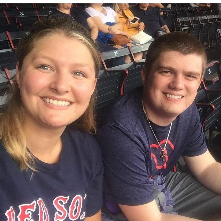 The bride and her younger brother enjoying a baseball game together!