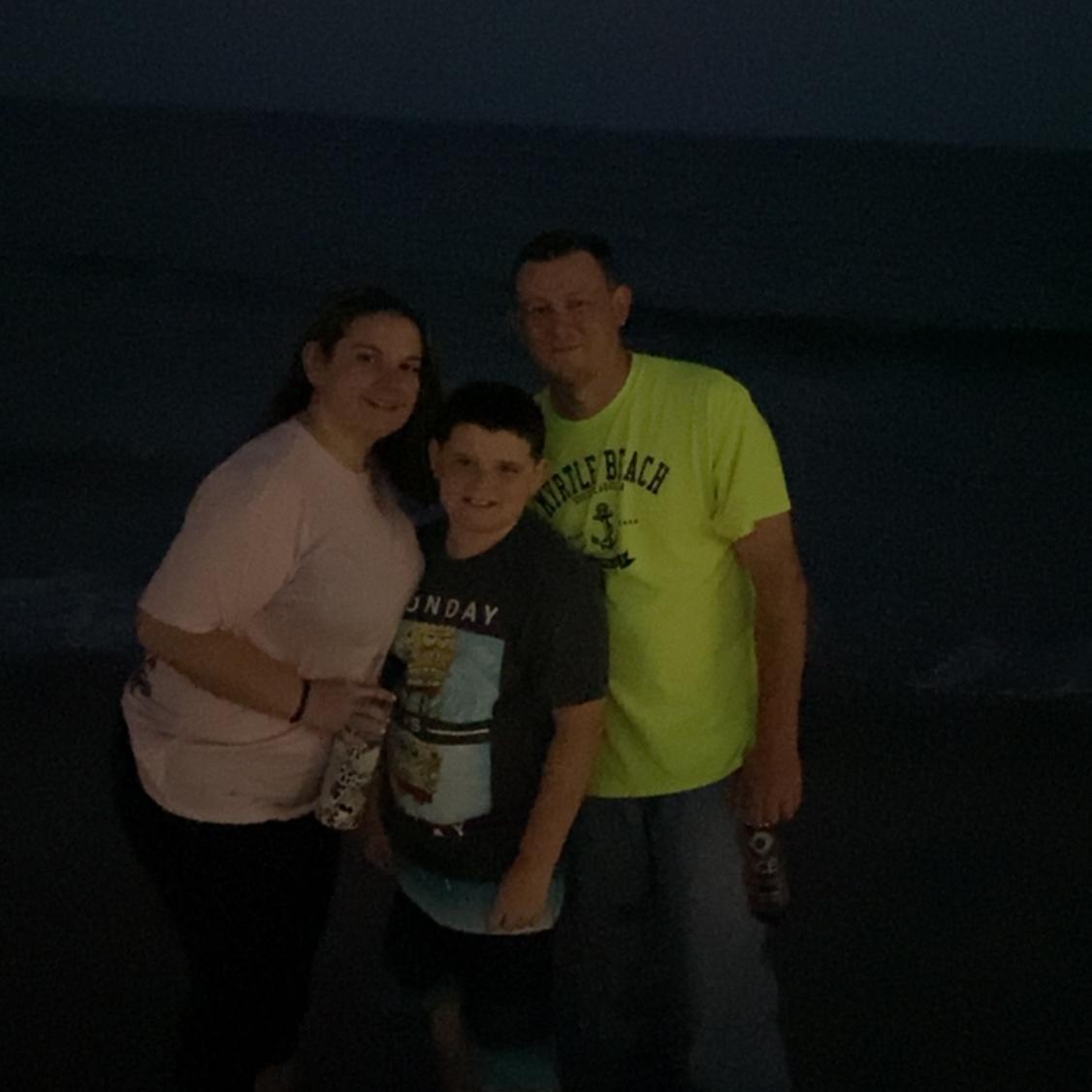 Family photo at the beach, a little dark