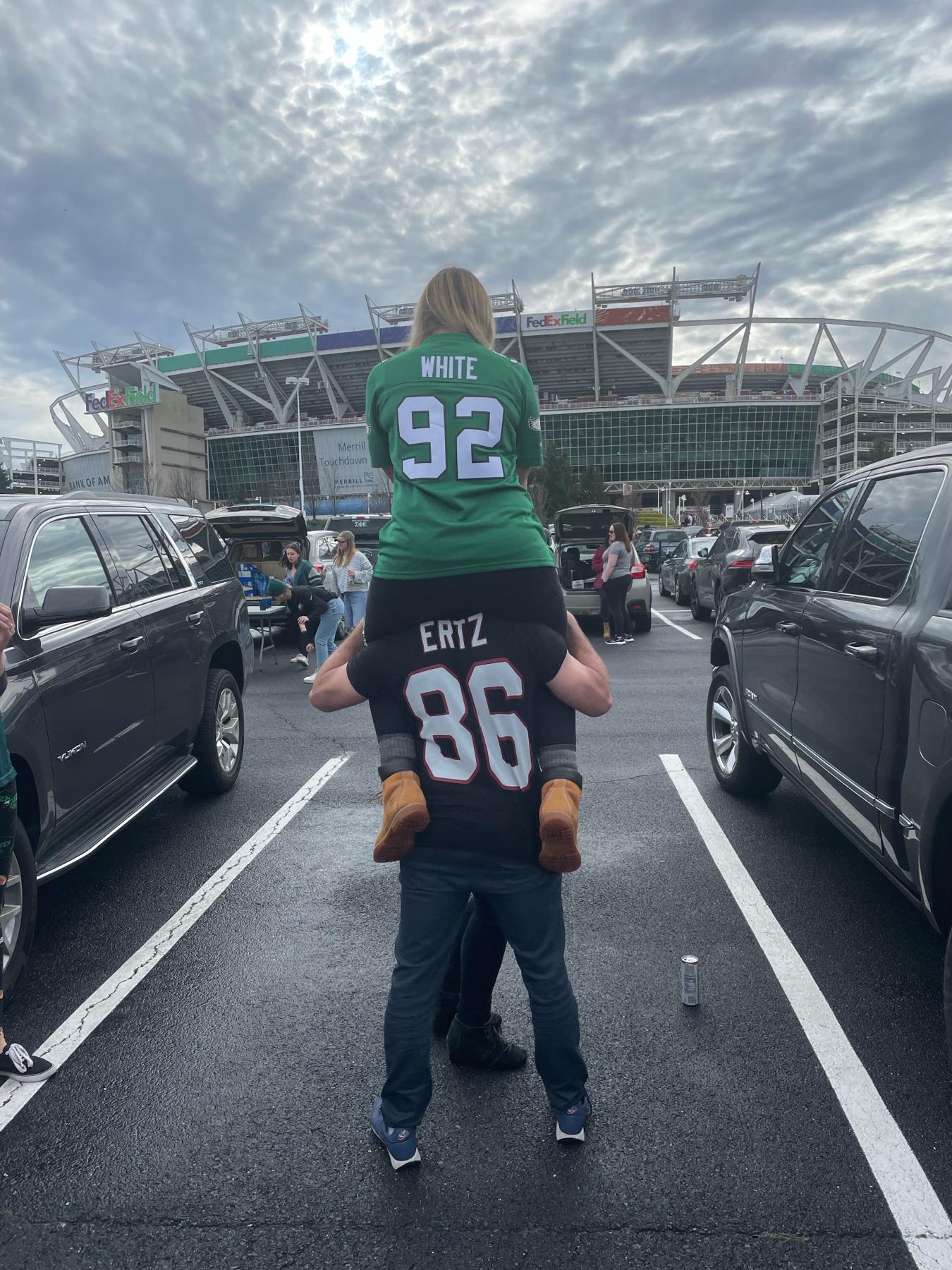 Two birds of different feathers- tailgating together. Go birds!