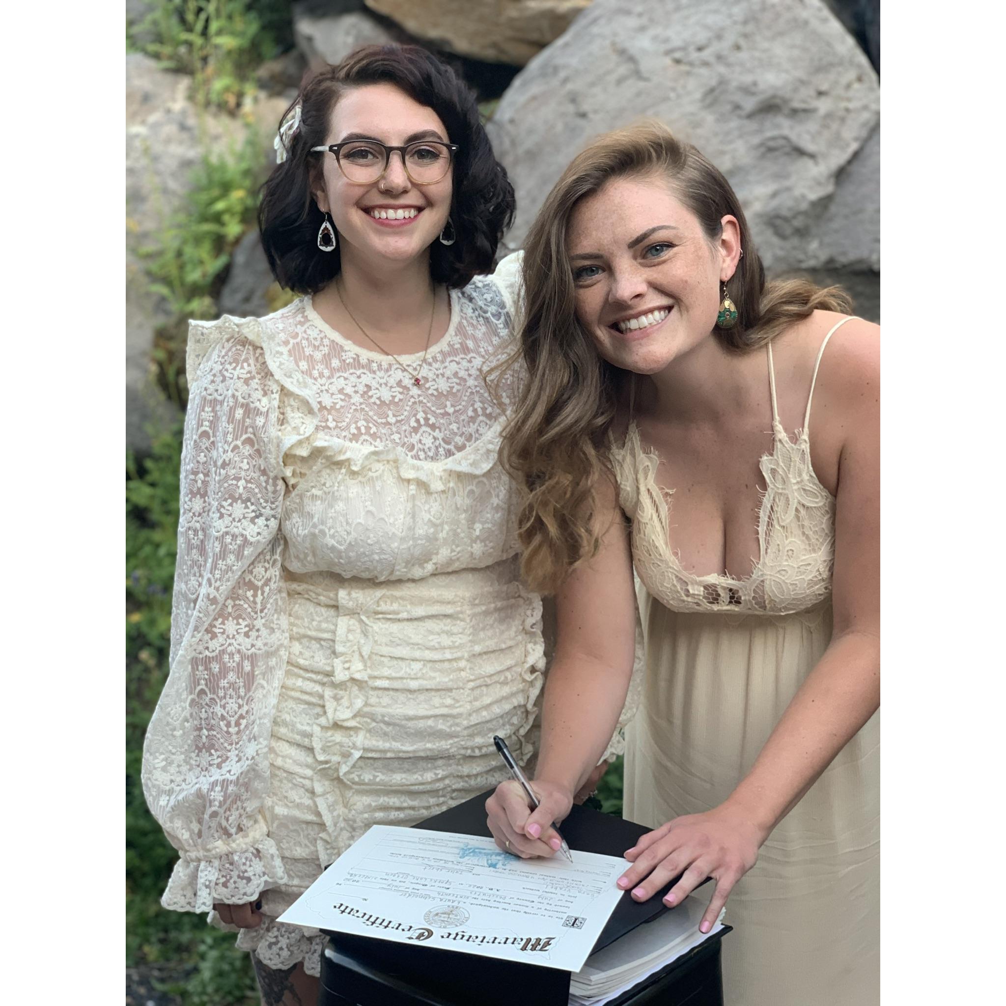 Sara & Hayley, maid of honor, signing the marriage certificate.