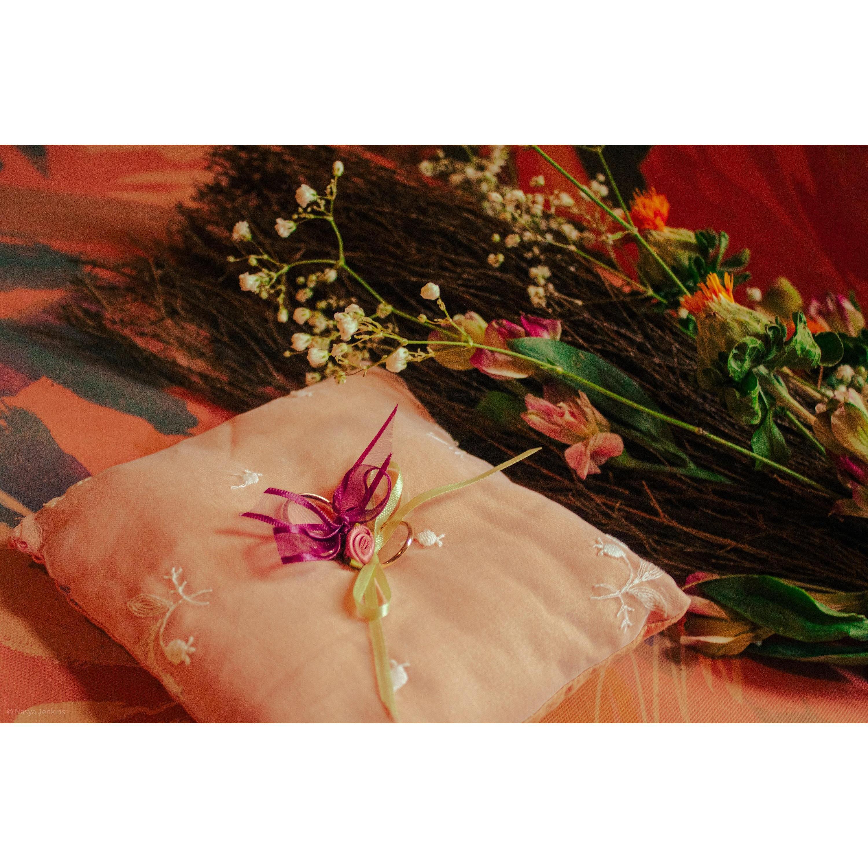 I hand made the pillow for the rings the morning of, and the cinnamon broom was decorated with flowers that were used in the bouquet the night before
