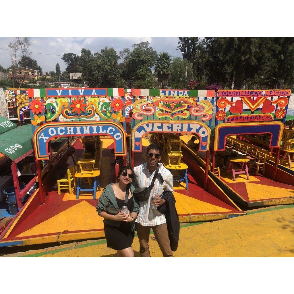 In front of the trajineras (colorful boats) in Xochimilco, Mexico.