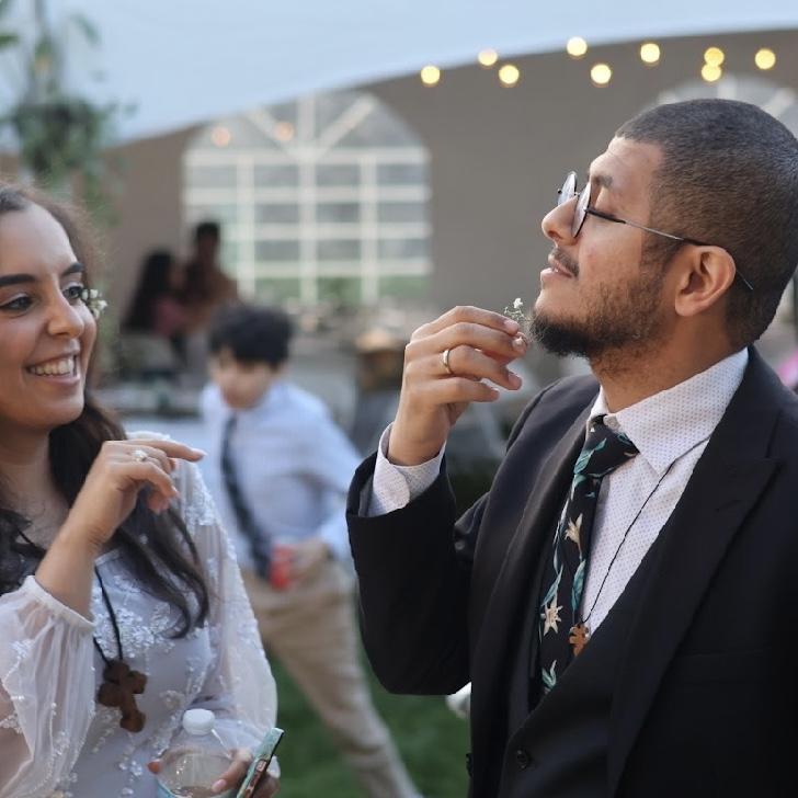 Maria enjoys putting flowers in David's beard