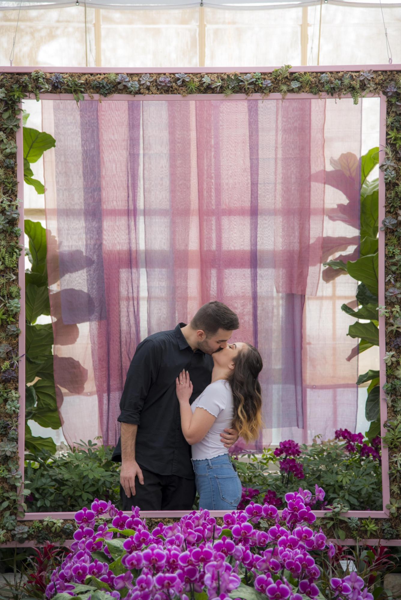 Here we are kissing right after getting engaged at the Franklin Park Conservatory on February 16, 2022.