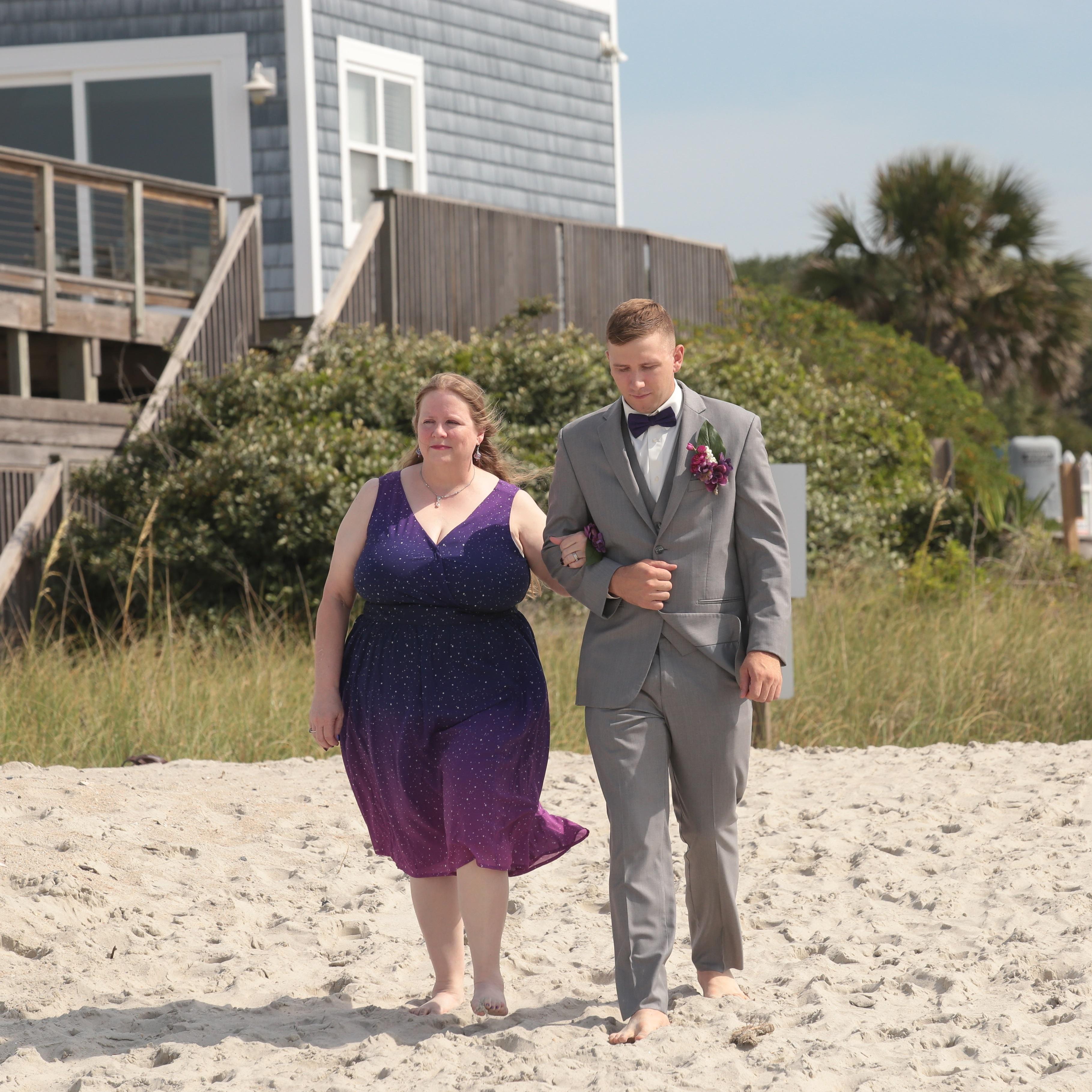 Nick walking his mom down the isle