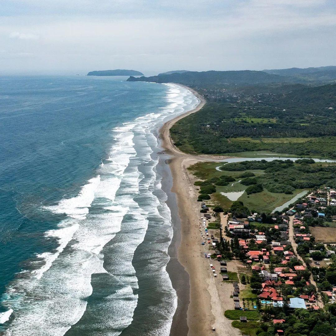 Aerial view of Ayampe town and the long stretch of beach coastline