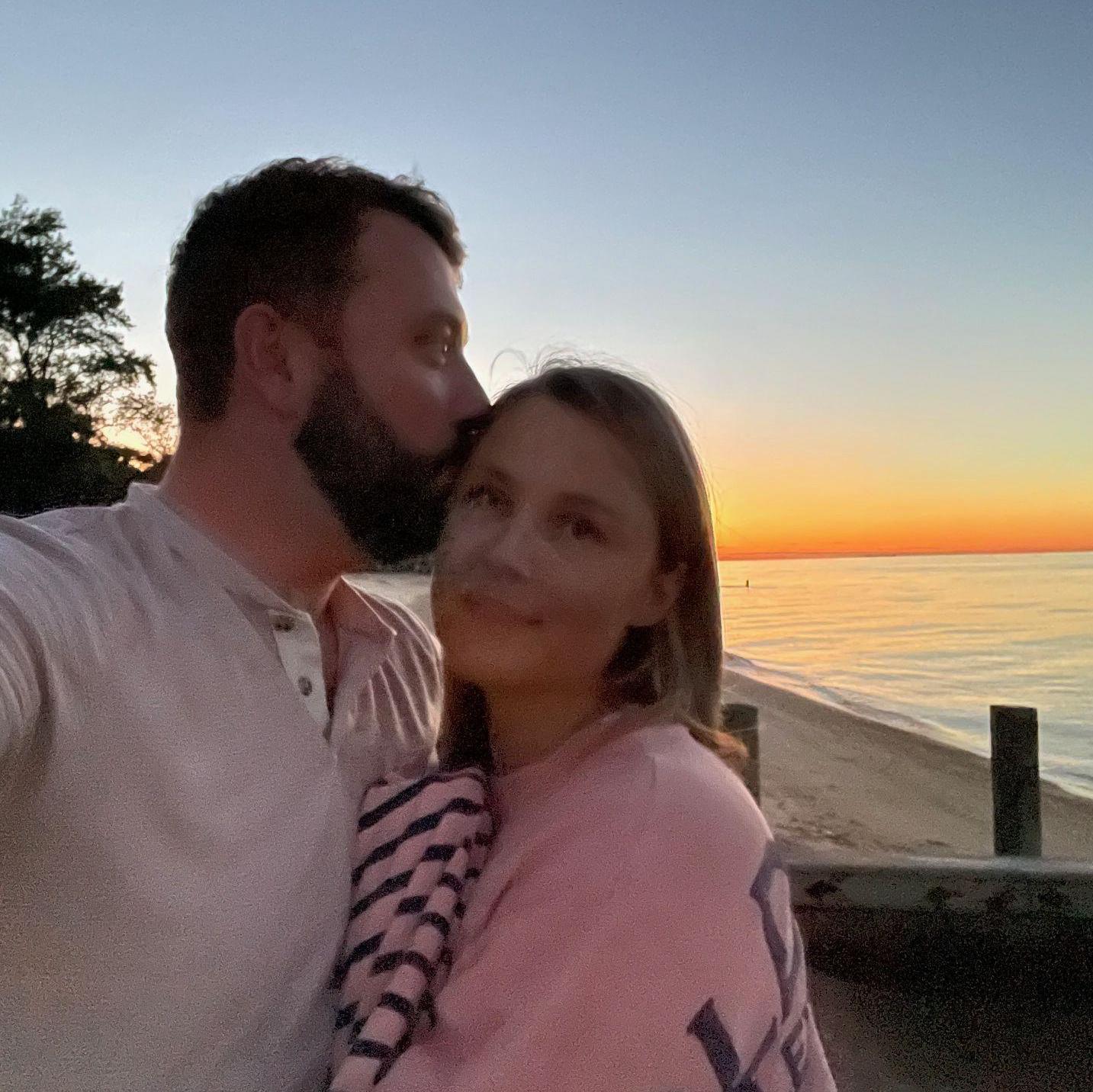 A kiss right in front of the beach house.