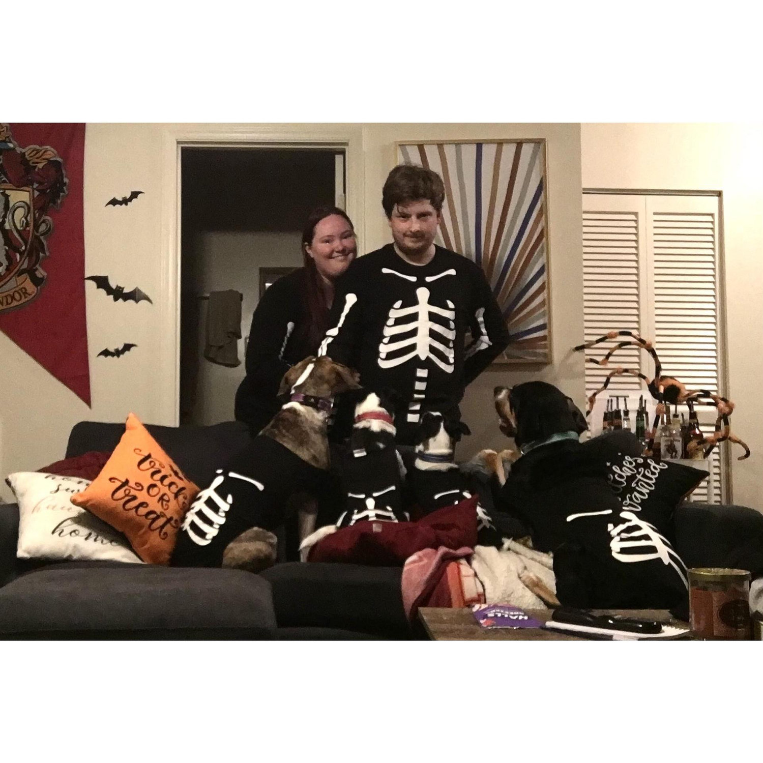 Danielle, Paul, Leia, Lily, Luna, and Bucky in matching skeleton pajamas around Halloween.