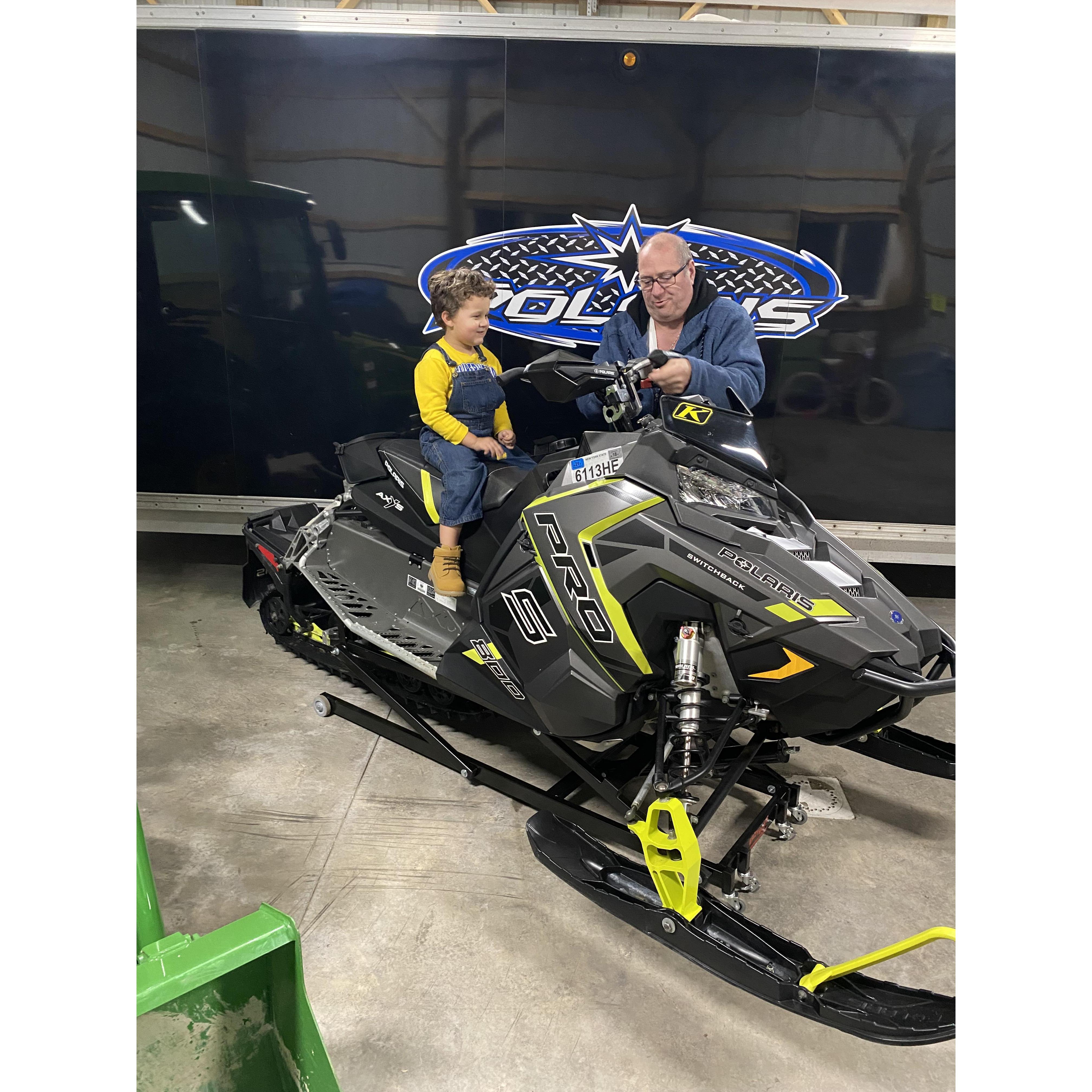 Learning about snowmobiles from Uncle Keith.