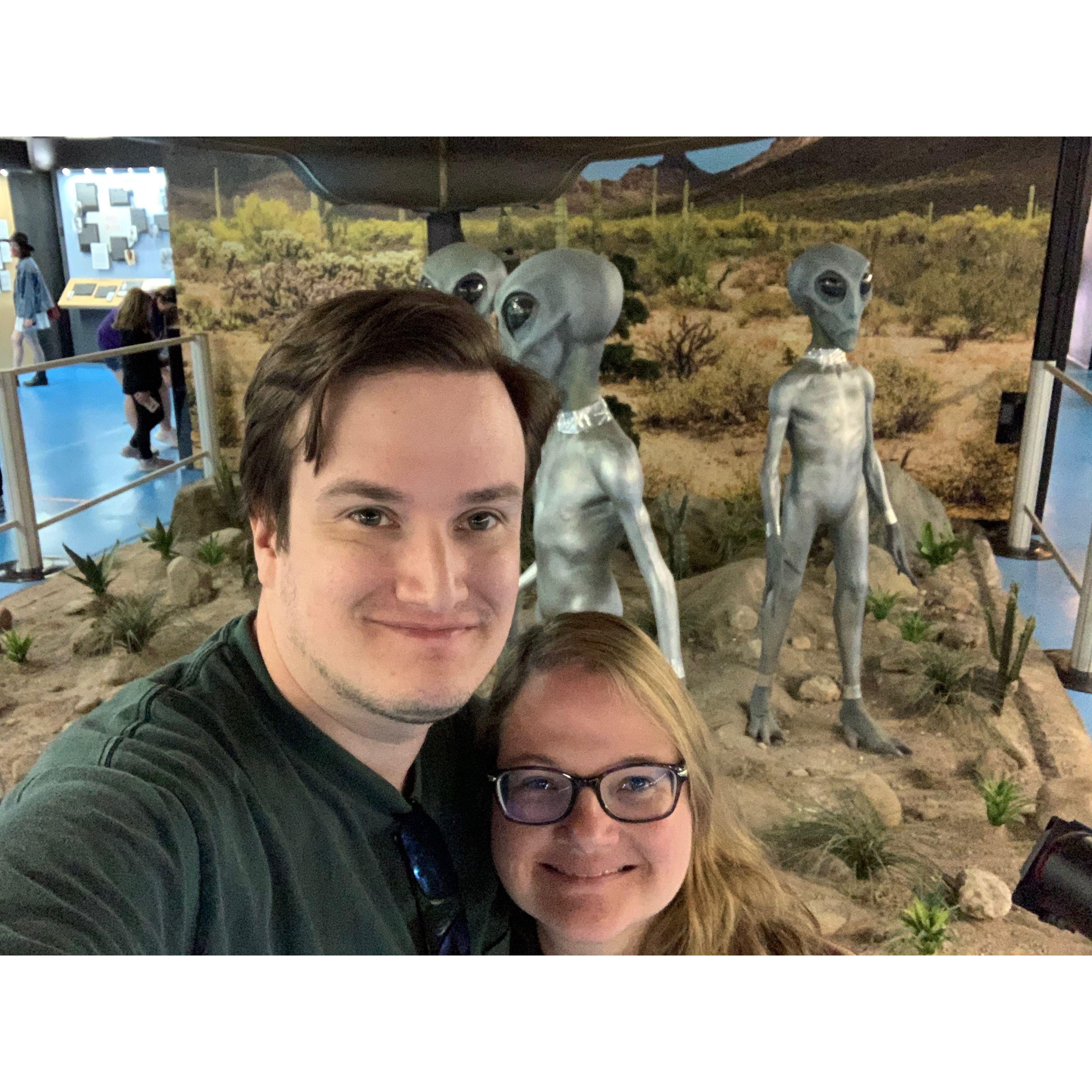 Selfie in front of 3 alien sculptures at Roswell UFO Museum.