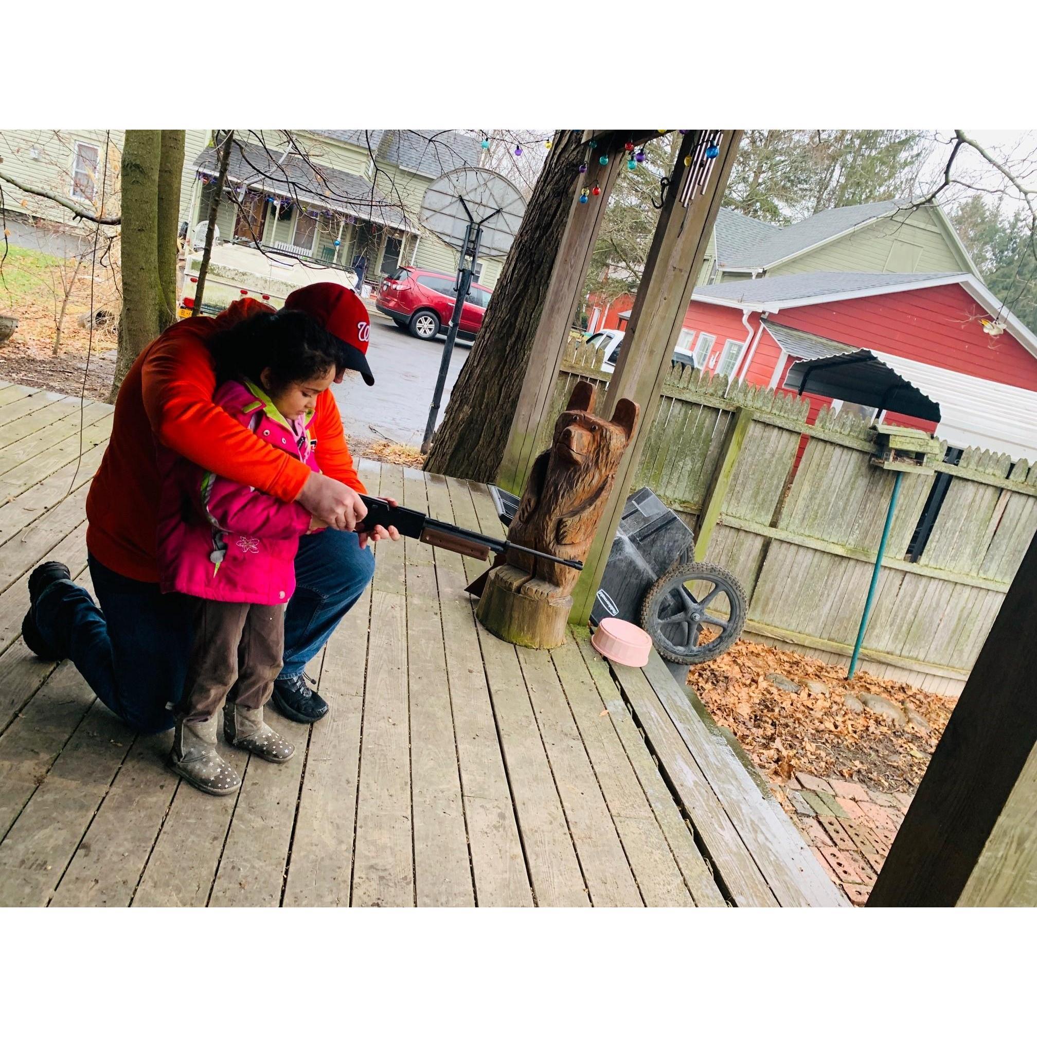 Dad is teaching Hayden how to shoot a gun.  Our little Tom Boy.