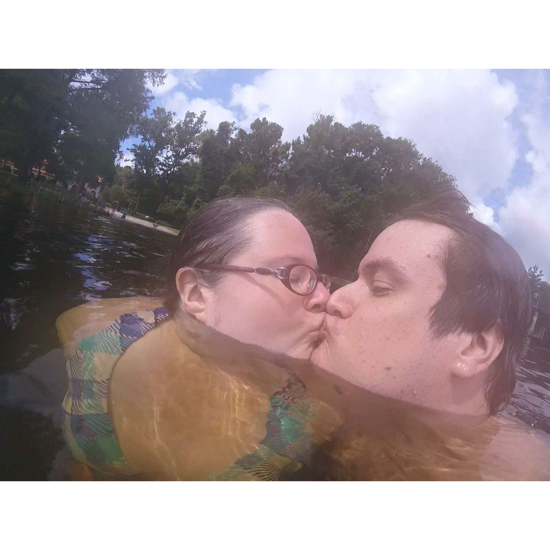Olivia and Zac kissing while swimming in Wakulla Springs.