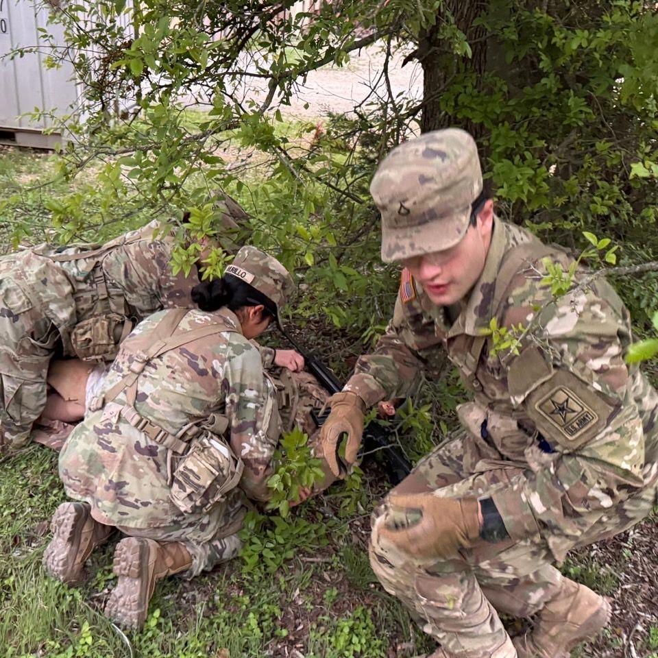 Alex and Angel treating a casualty during a field training exercise
