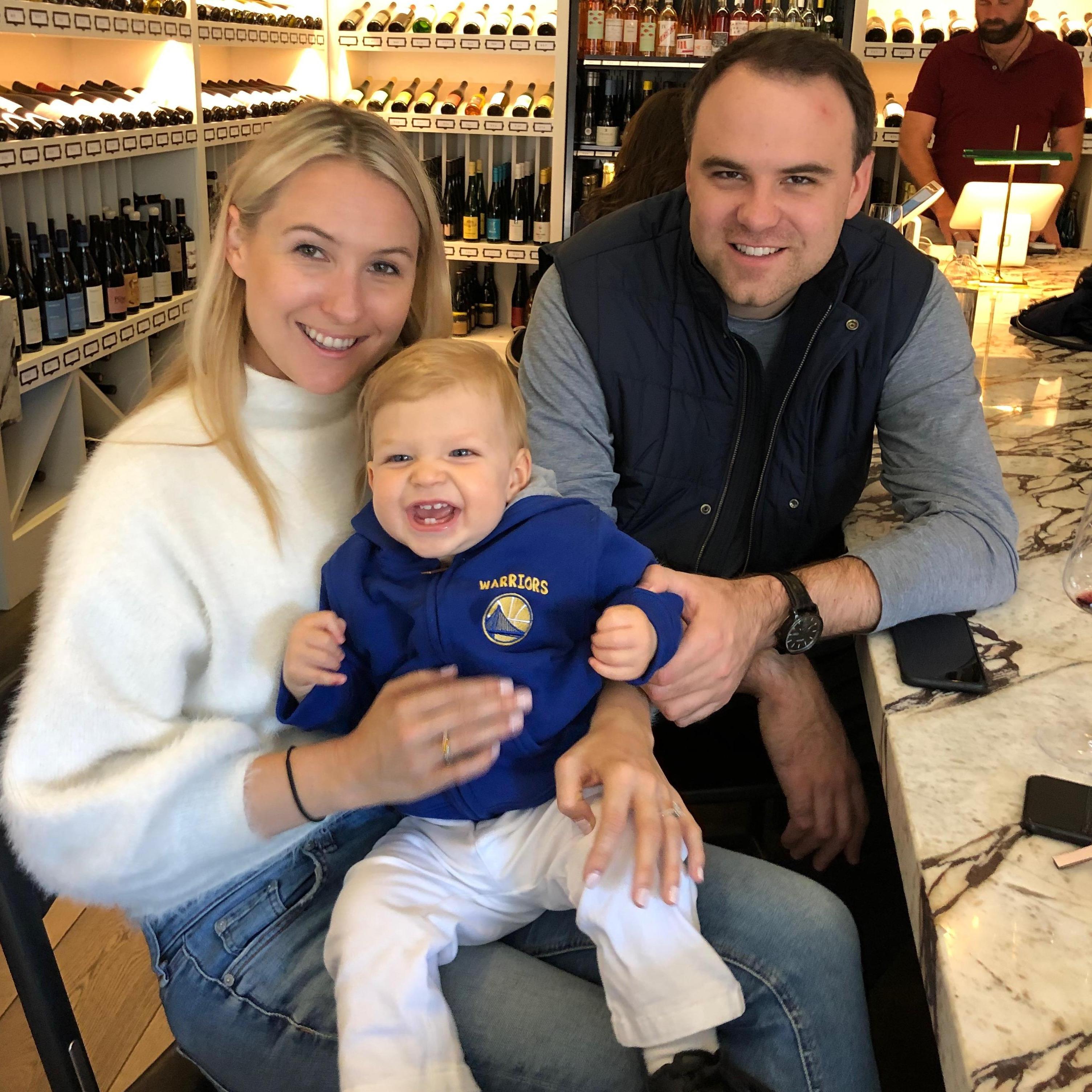 Liam getting into the SF culture: at a cool SF wine bar wearing his Warriors swag.