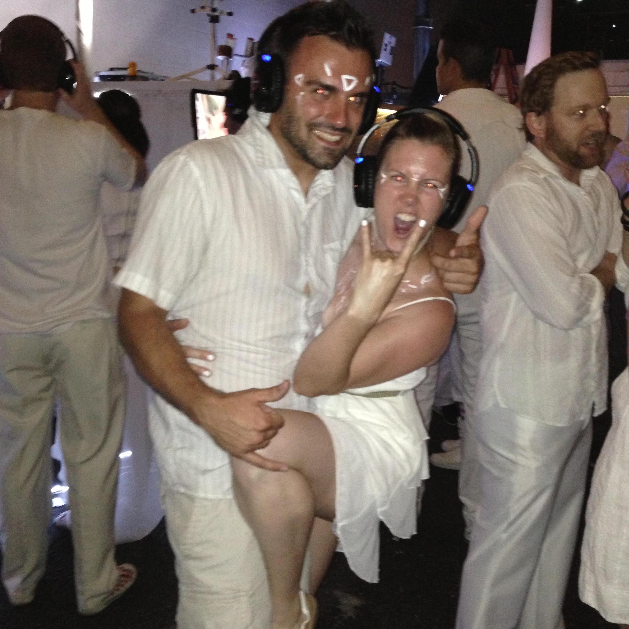 At a white party in downtown LA, silent DJ and glow in the dark paint. YEAYA