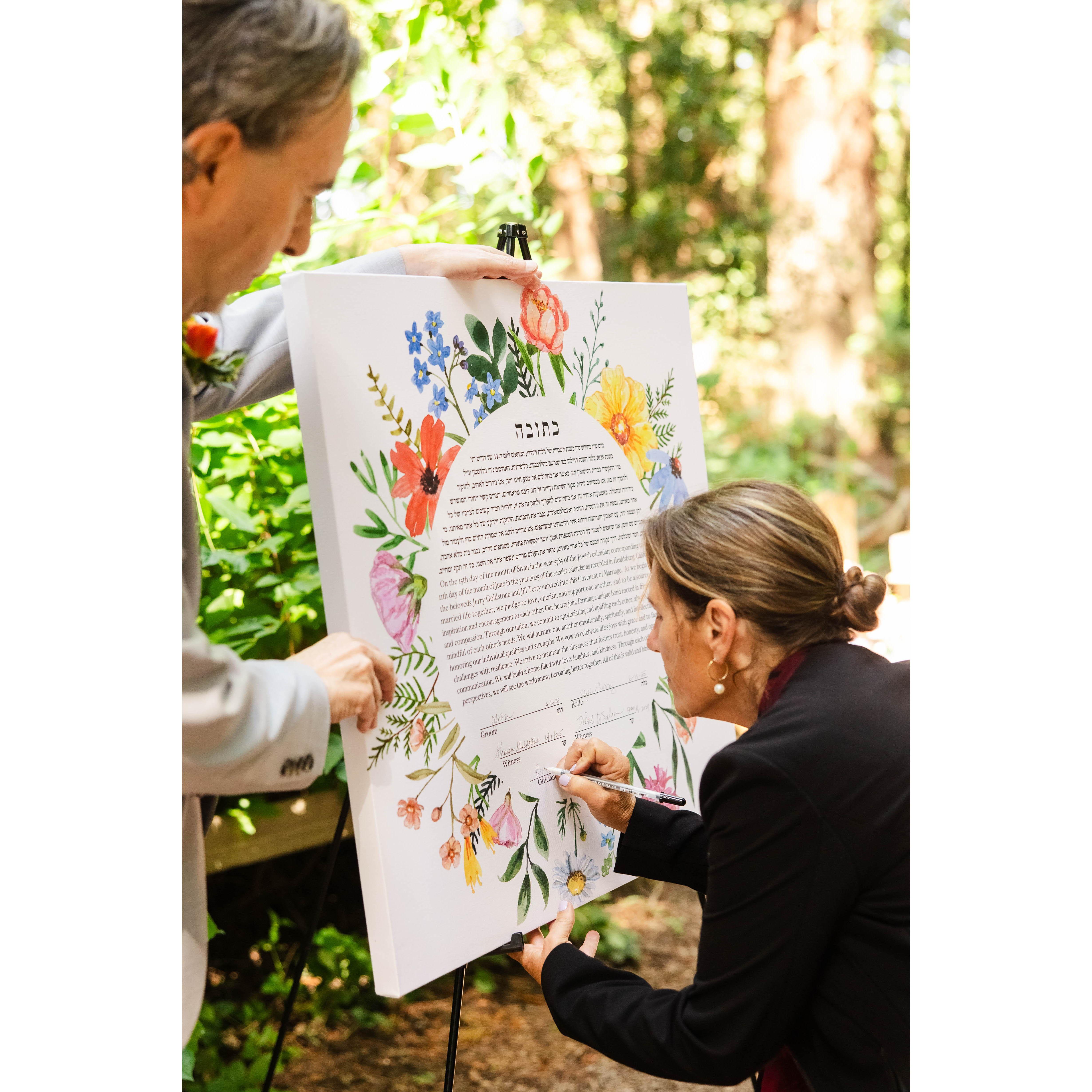 Officiant Rose Barboza signs the ketubah to make it official