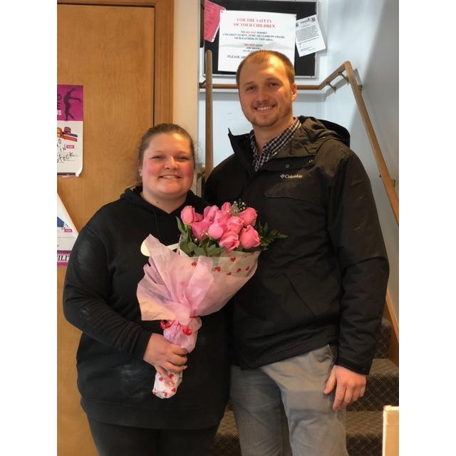 Dan brought Carlee flowers on Valentines Day to the Gymnastics where Carlee works.