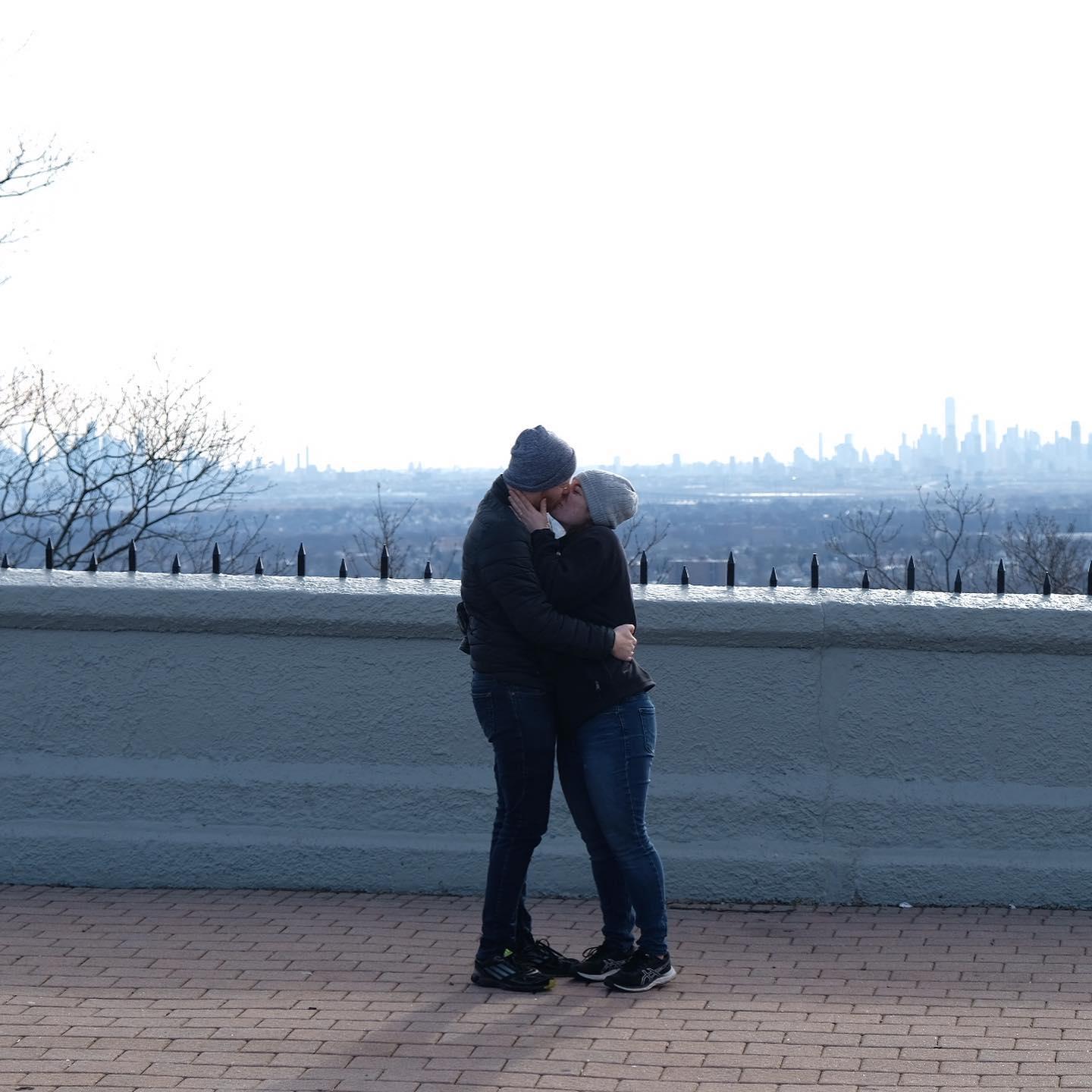 Step 2: Con her into standing right in front of the Manhattan skyline.