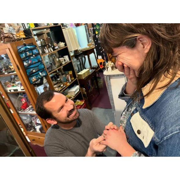 Proposal in Joan's happiest of places, an antique shop.