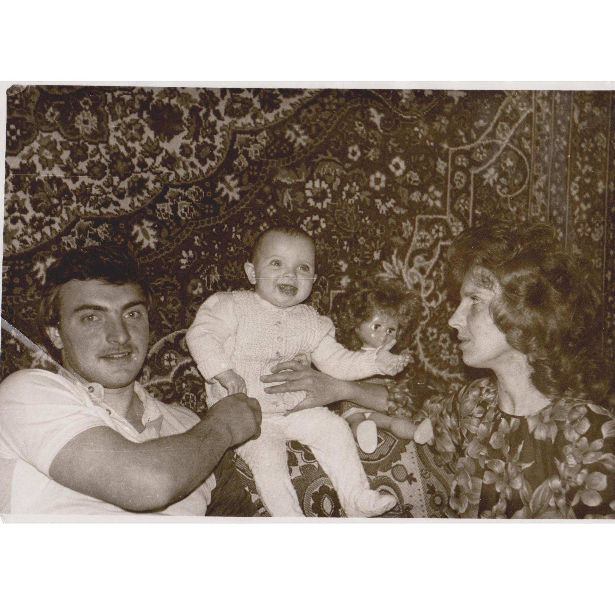 Yulia's a baby, with mom and dad.